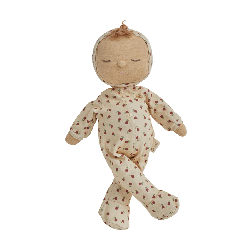 A plush baby doll with a beige fabric face and closed eyes, wearing a cream-colored long-sleeve pajama suit with a small red floral pattern, set against a plain white background.