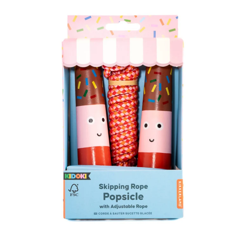 A boxed children's skipping rope toy called Popsicle by Kidokk, shown in its retail packaging against a plain white background. The product inside has two pink-and-brown candy-themed handles with colorful sprinkles and a red-and-white patterned rope.