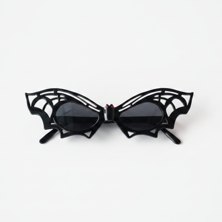 A pair of black spiderweb-themed cat-eye sunglasses displayed on a clean white background.