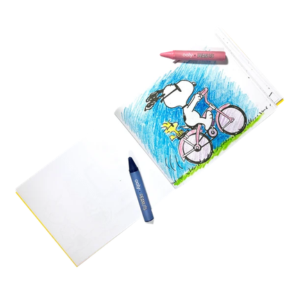 Coloring book with a cartoon character on a bicycle and two crayons next to it.