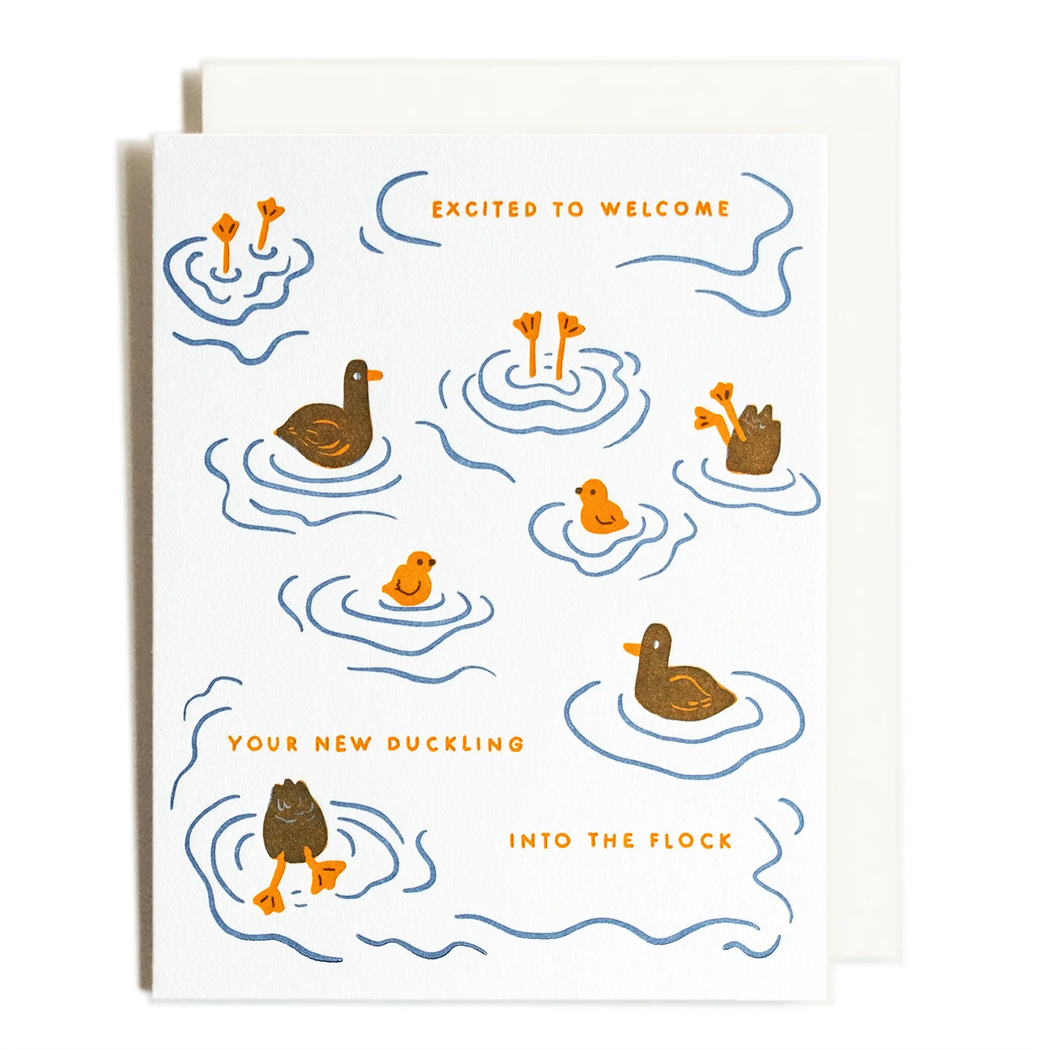 A greeting card with duck illustrations and the text 'EXCITED TO WELCOME YOUR NEW DUCKLING INTO THE FLOCK' shown on a white card with a matching envelope, photographed on a computer screen. The card is branded Letterpress Studio.