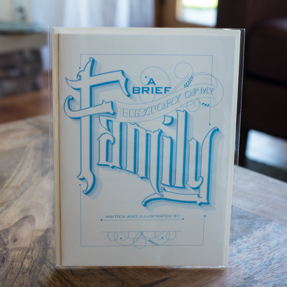 Book titled 'A Brief History of My Family' with blue text on a wooden surface