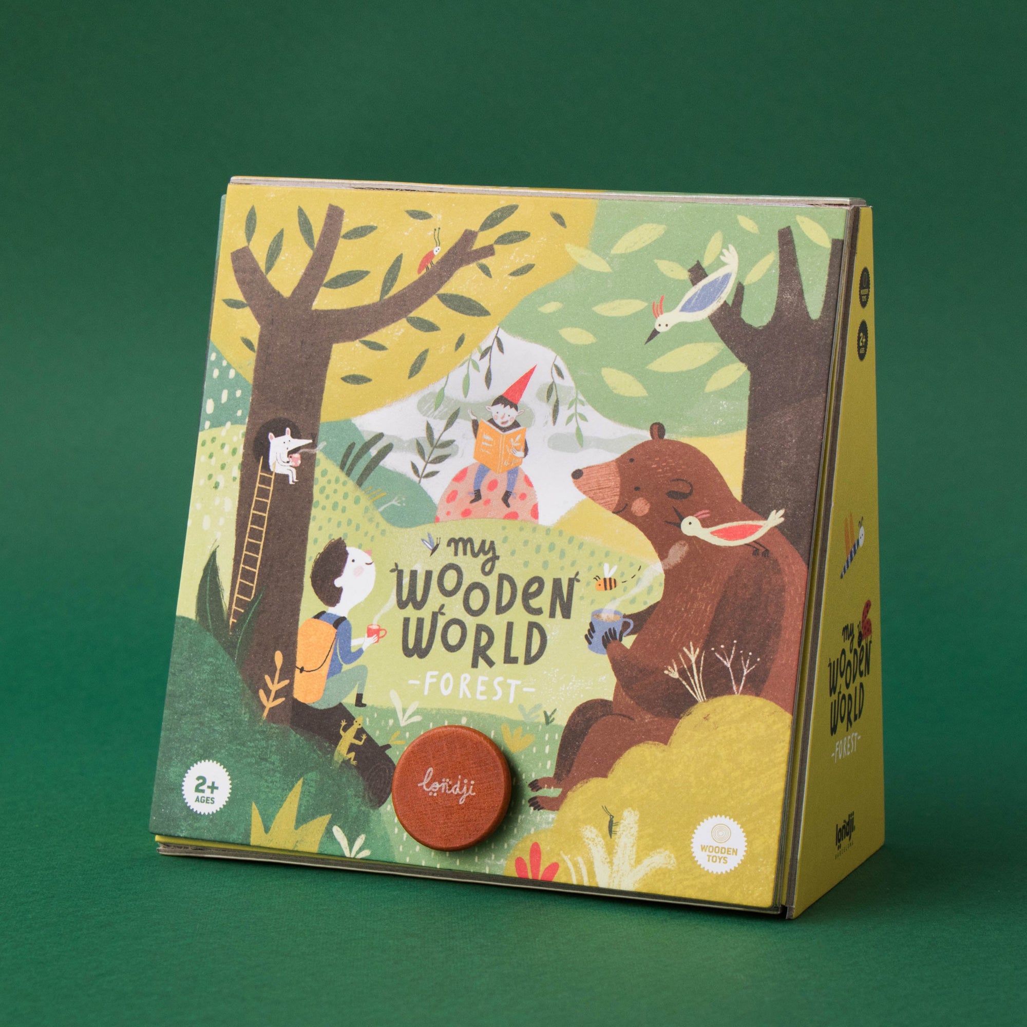 Children's book titled 'My Wooden World' with illustrations of a bear and children on a green background