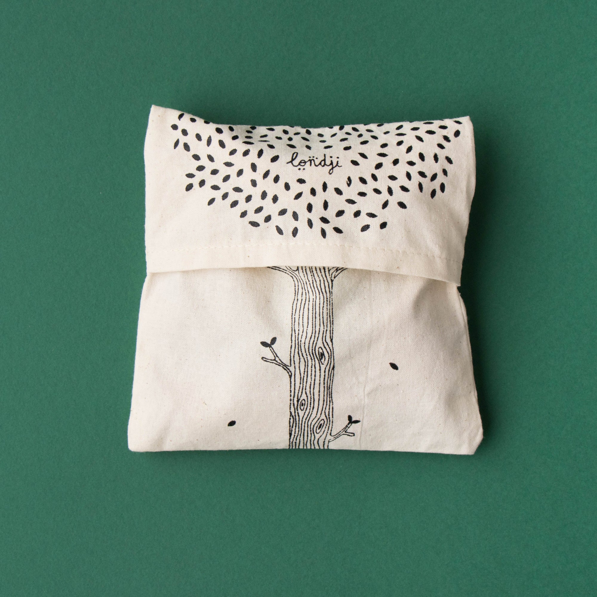 Canvas pouch with tree design on a green background