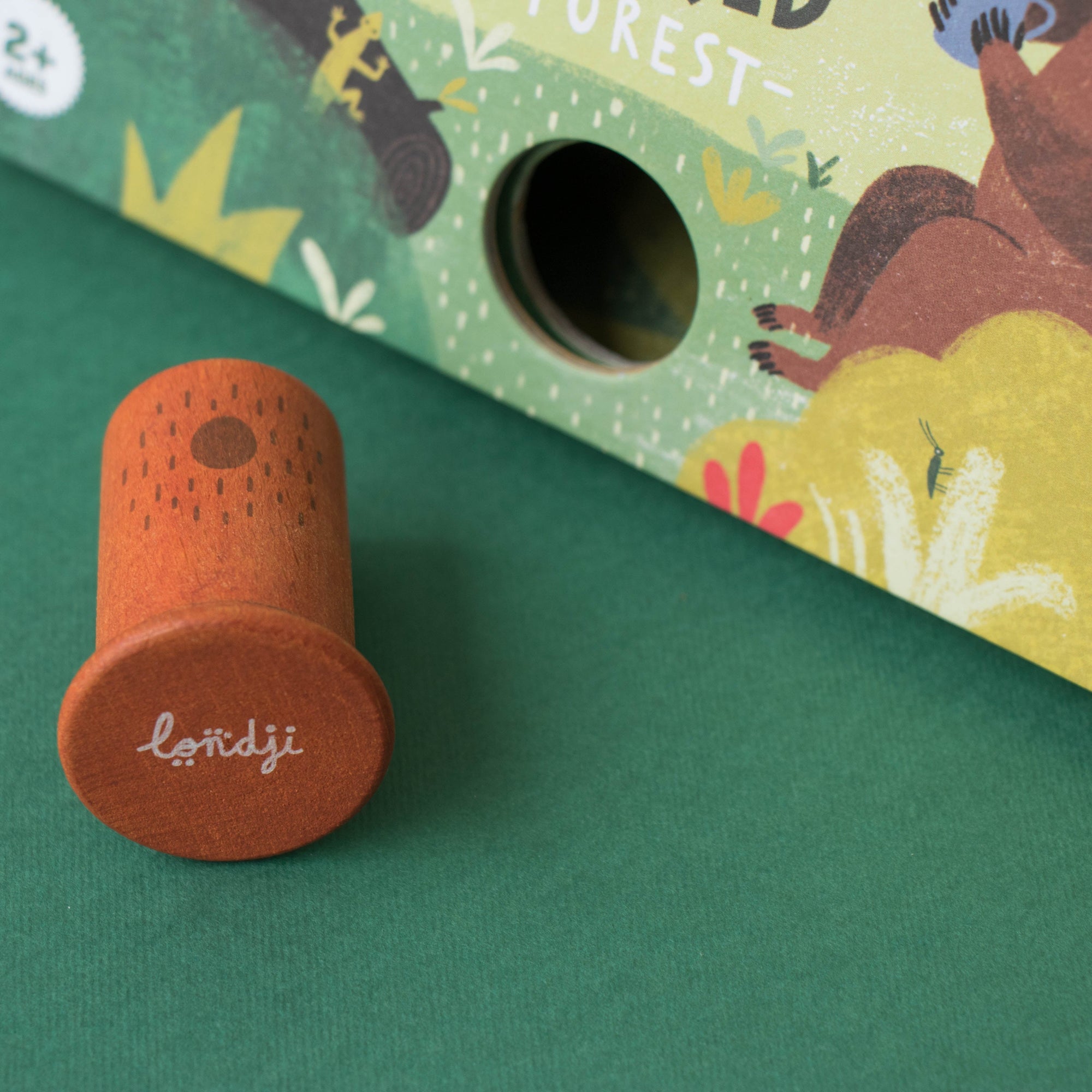 Wooden toy with 'londji' branding on a green background