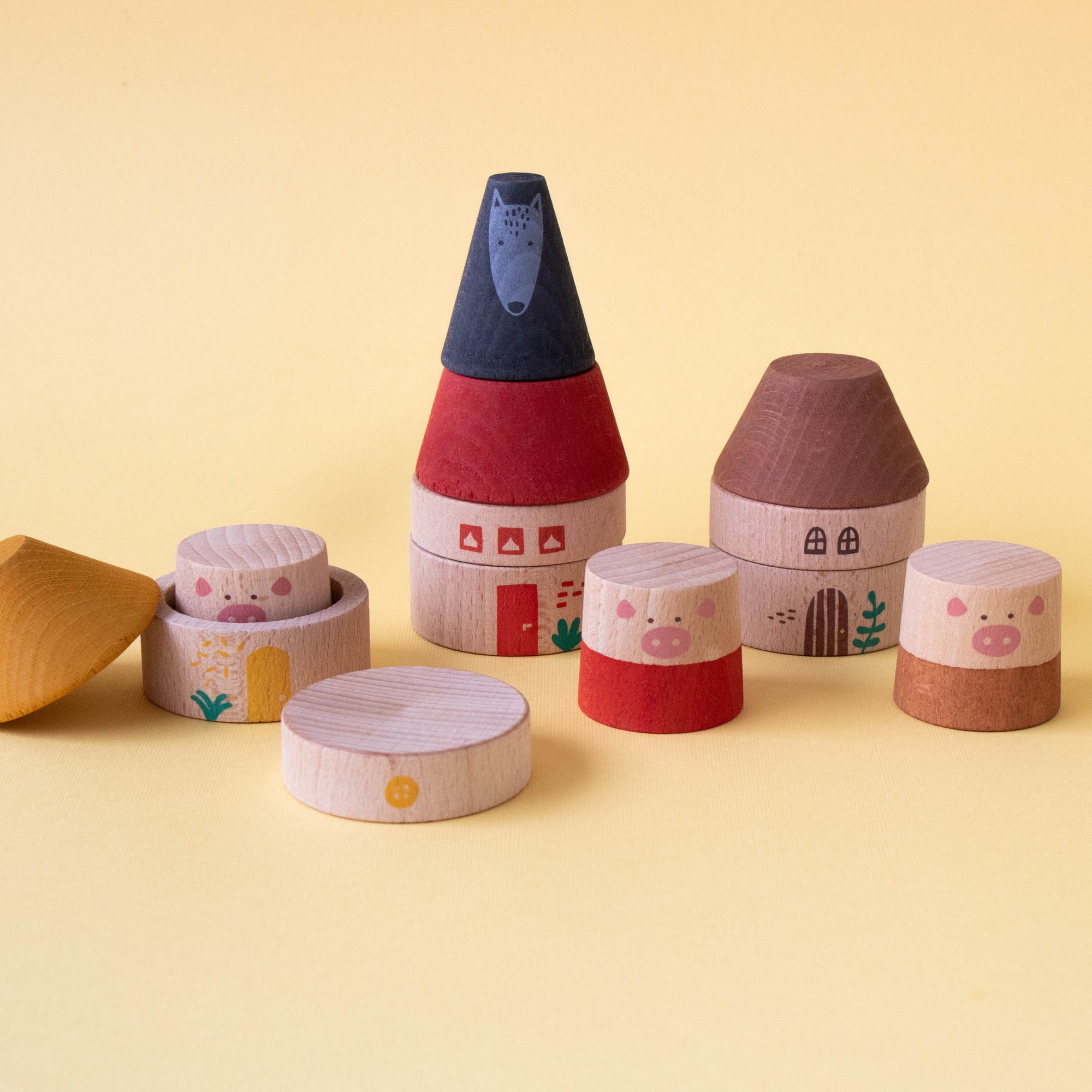 Set of wooden toy houses on a yellow background
