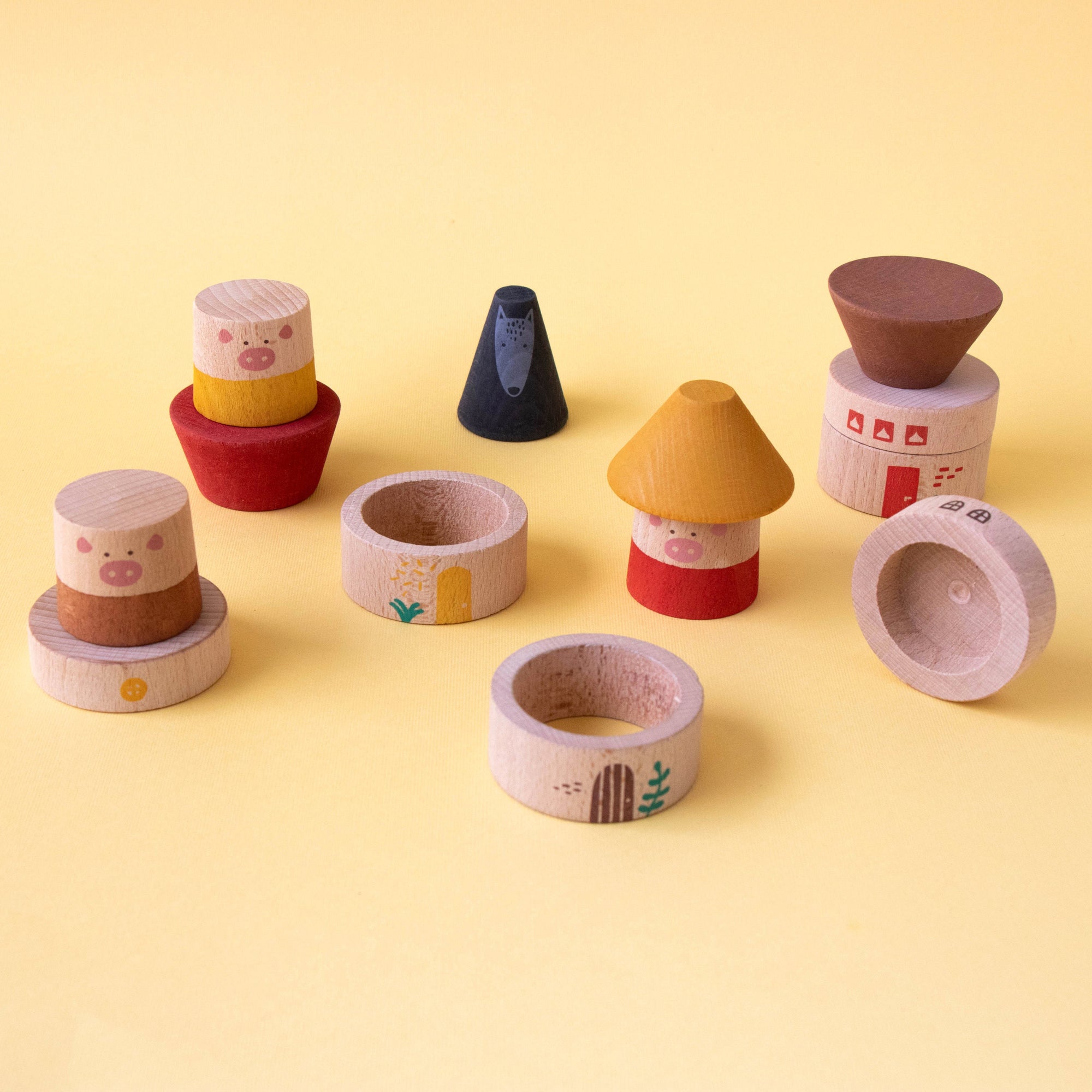 Set of colorful wooden toy pots on a yellow background