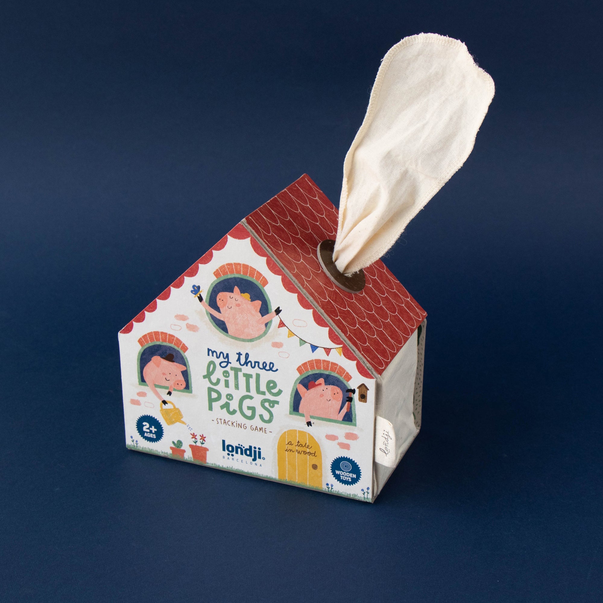 House-shaped tissue box with a tissue peeking out on a dark blue background