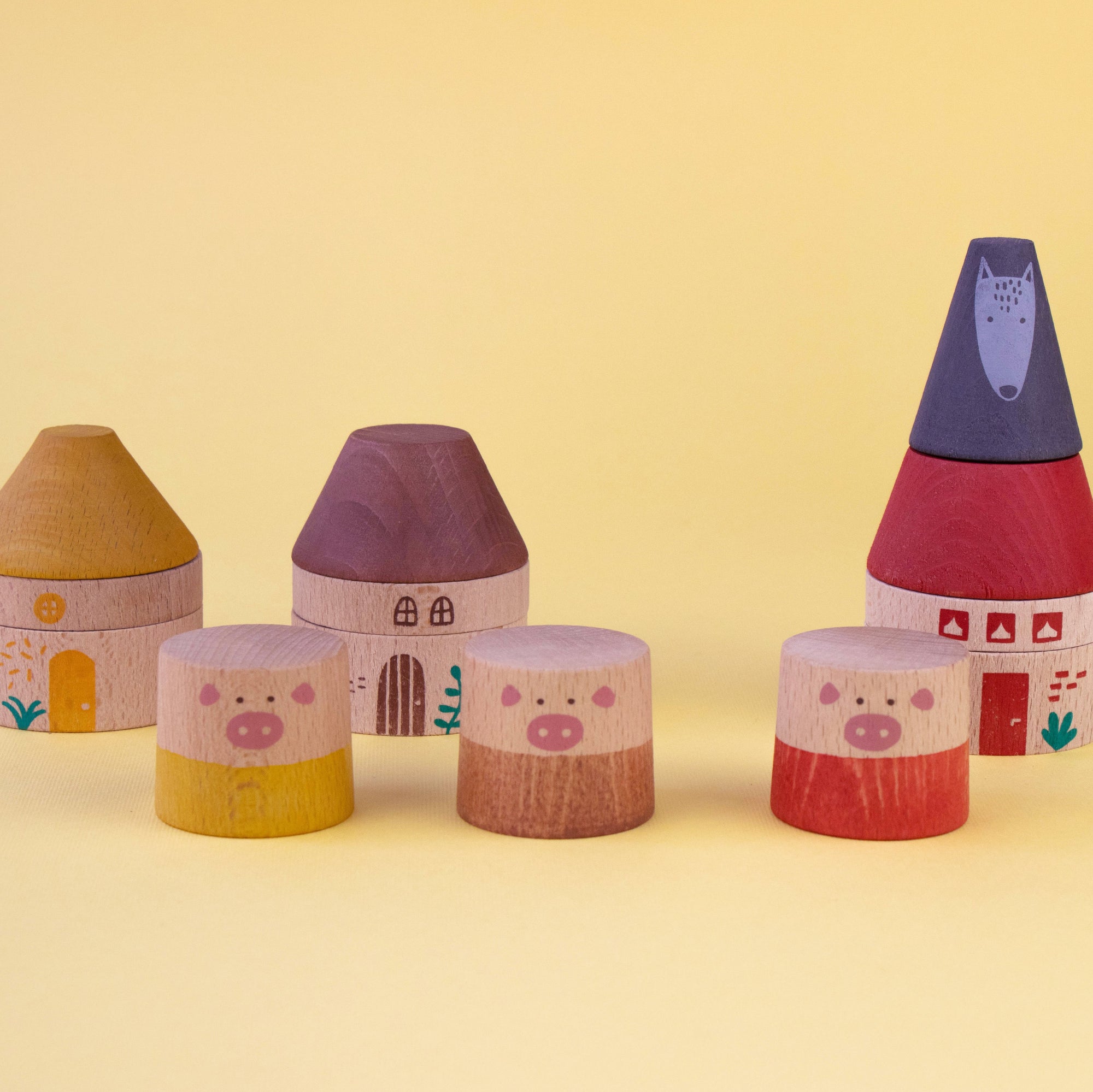 Set of colorful toy houses on a yellow background