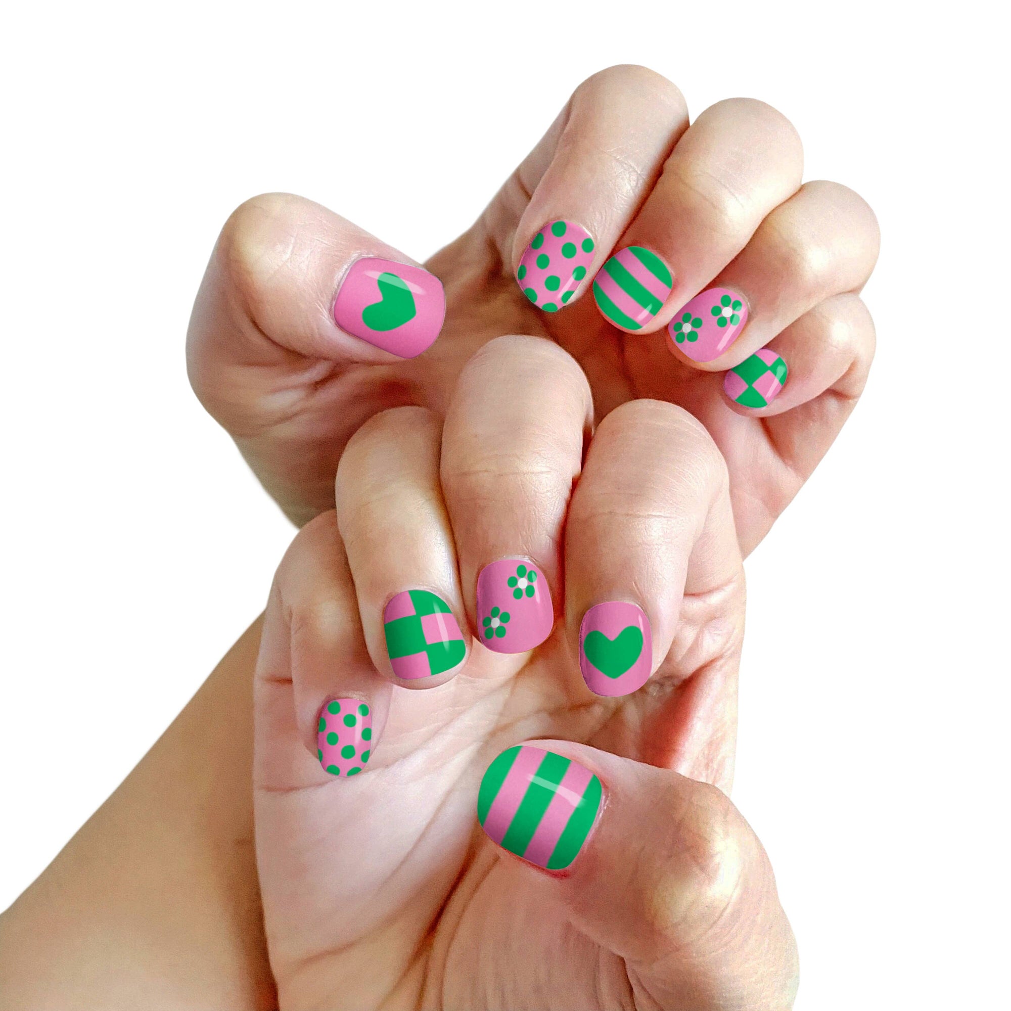 Hand with pink and green nail art on a white background