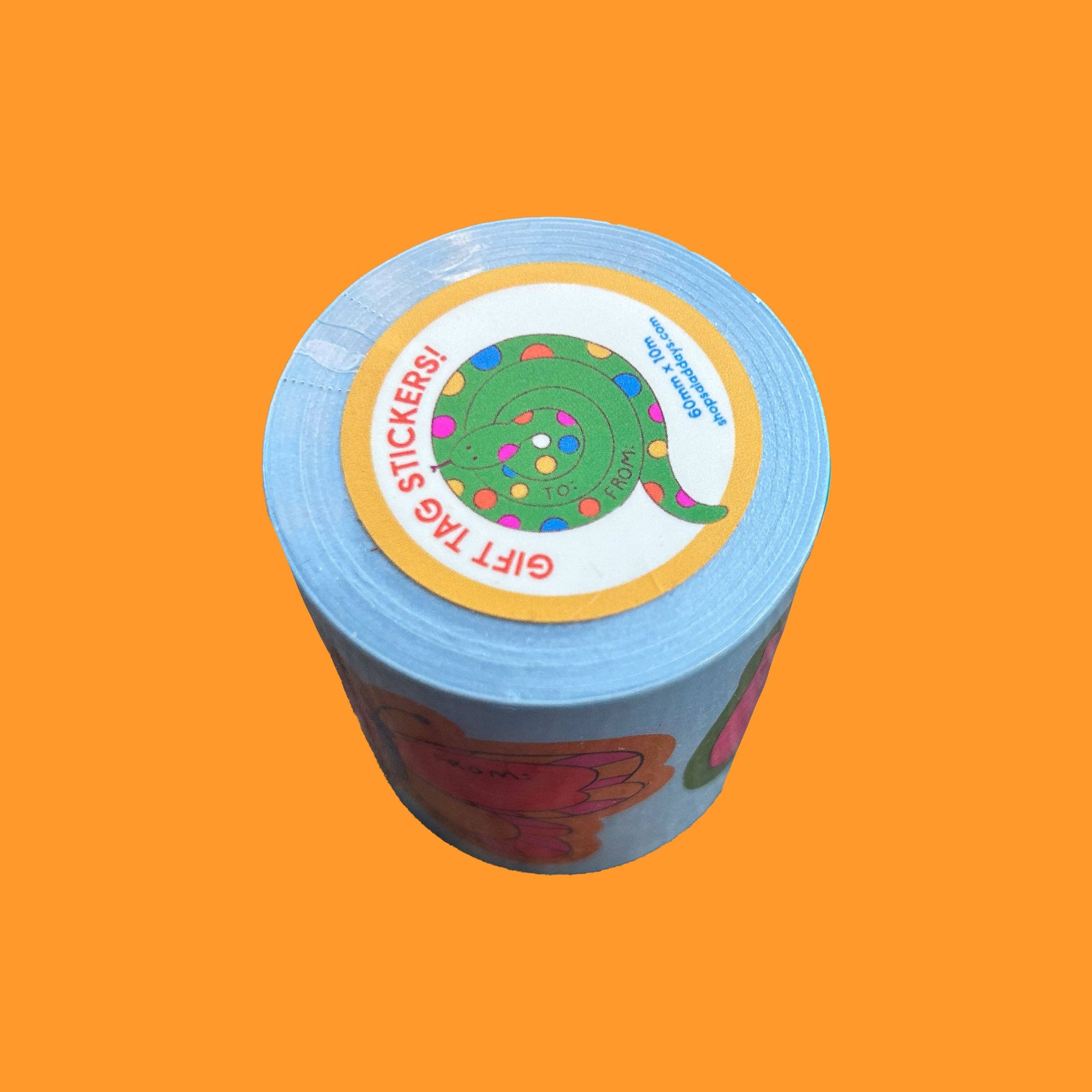 Roll of blue stickers with colorful labels on an orange background