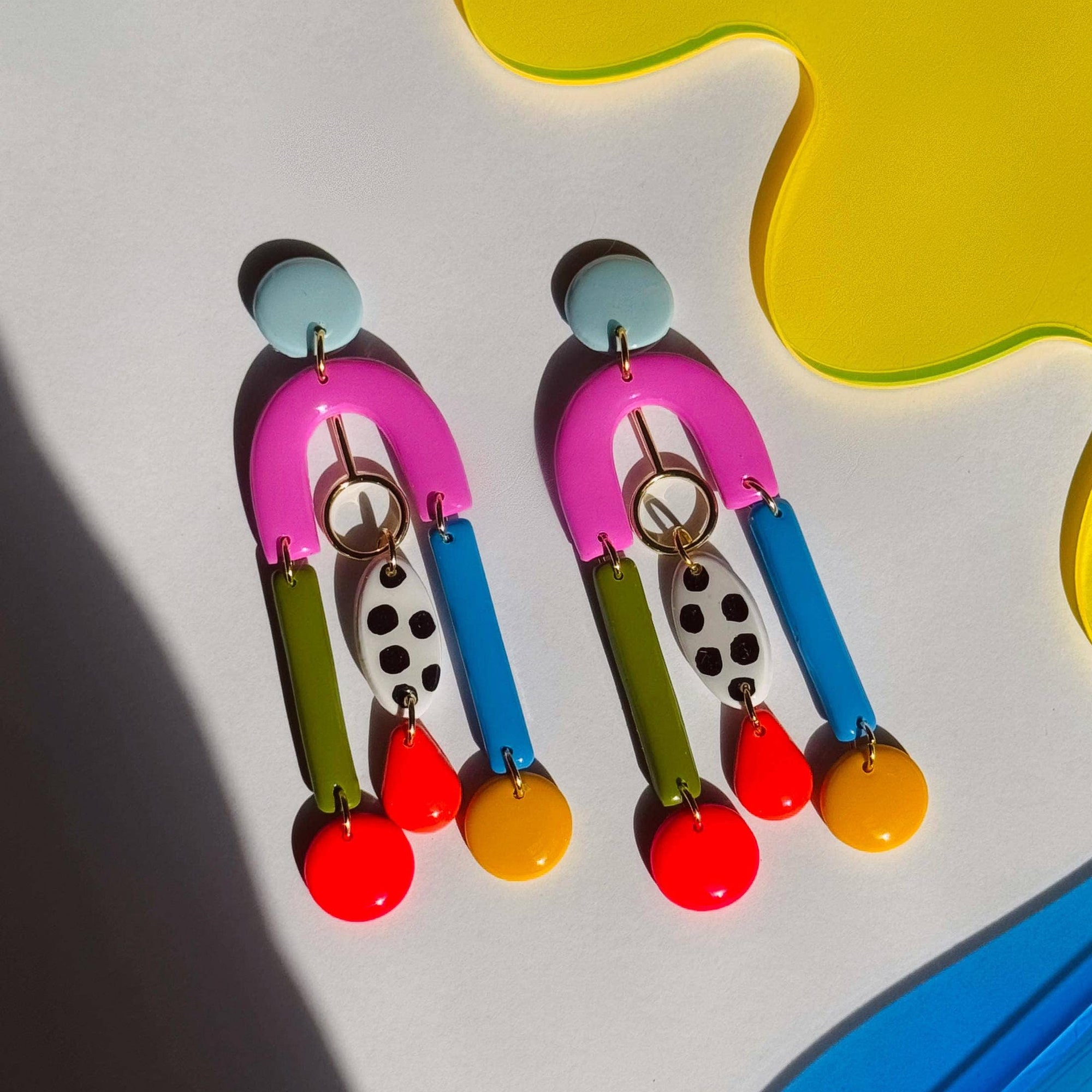 Colorful earrings with a geometric background