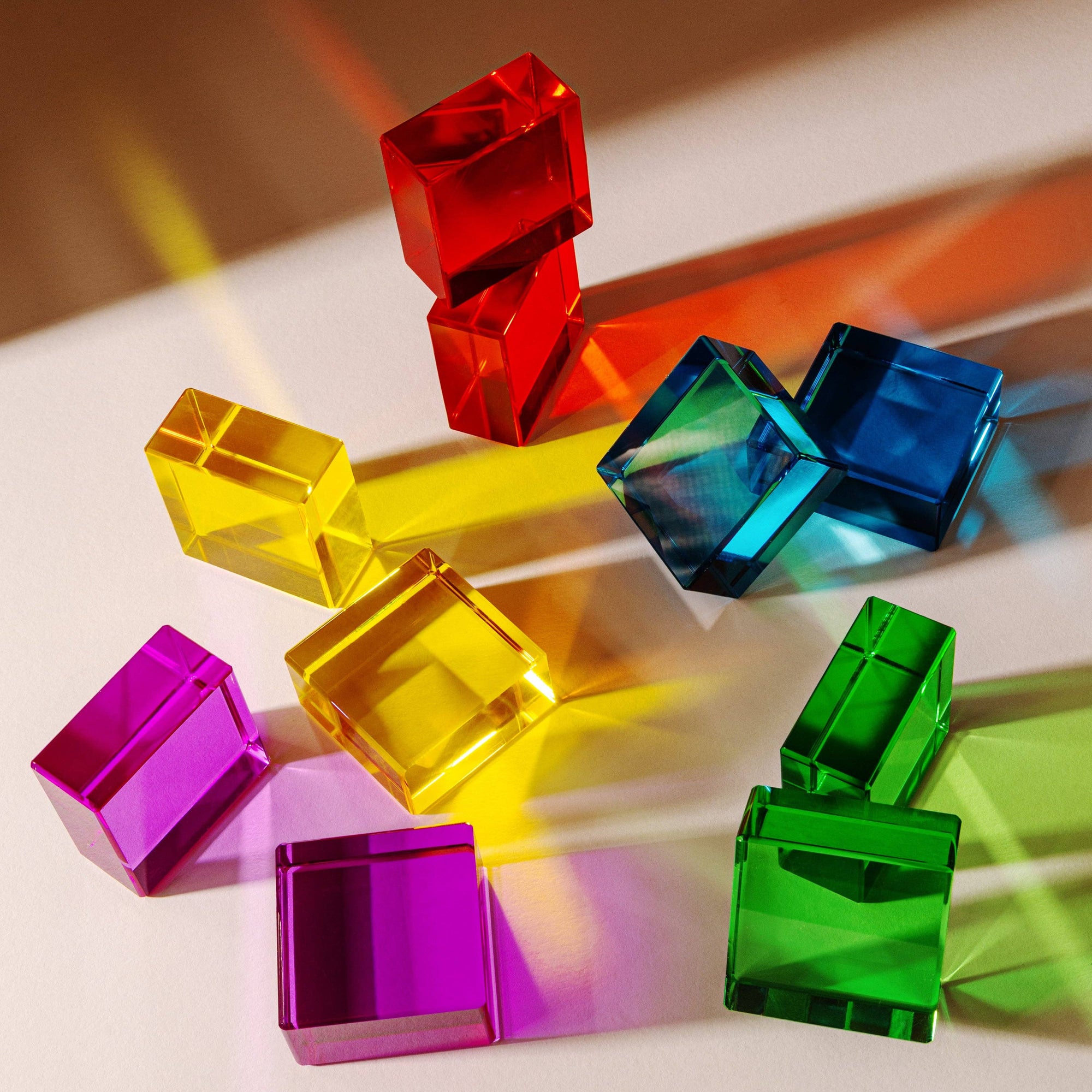 Colorful transparent cubes on a white surface with a gradient background