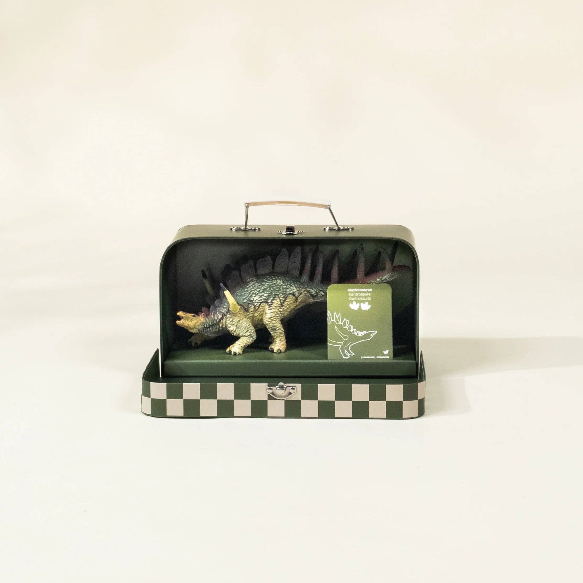 Dinosaur toy in a checkered box on a white background
