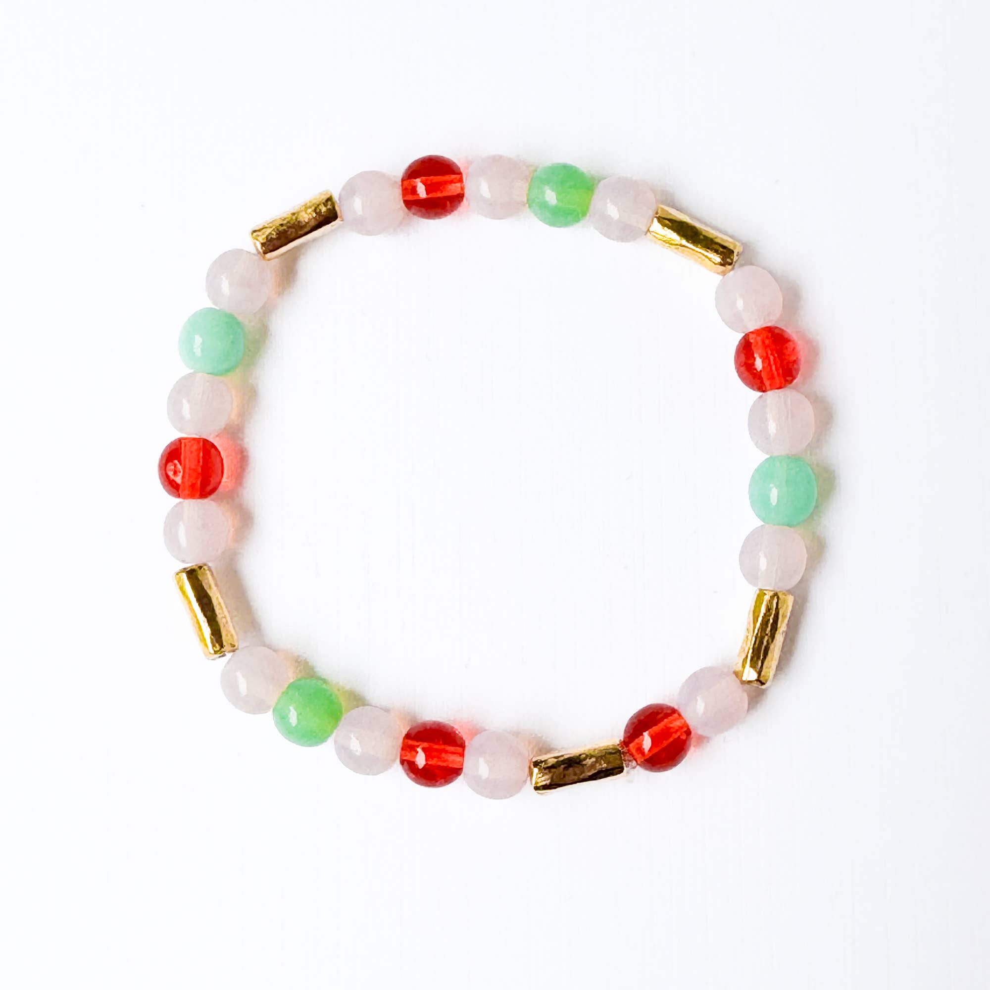 Multicolored beaded bracelet with gold accents on a white background