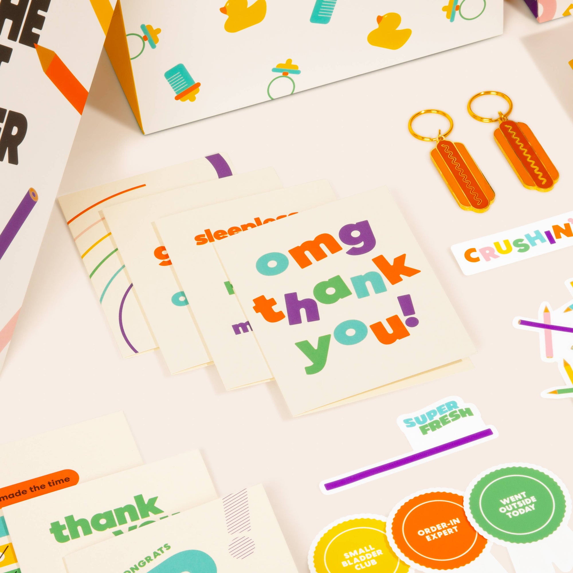 Colorful stationery items including cards and keychains on a white surface