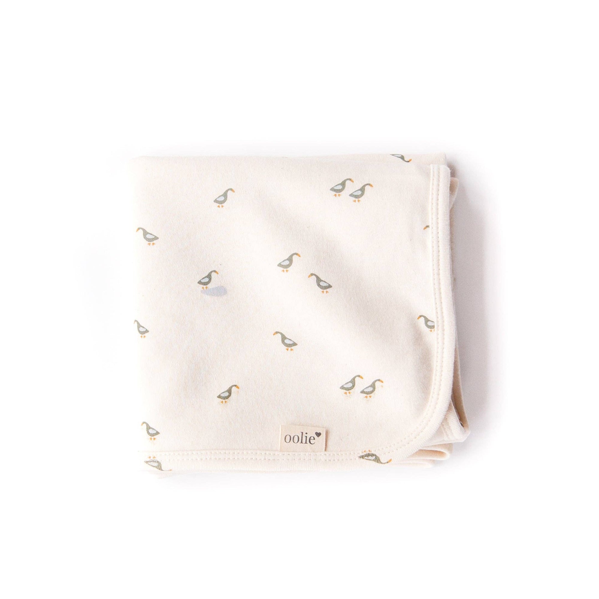Baby blanket with duck pattern and 'oolie' branding on a white background