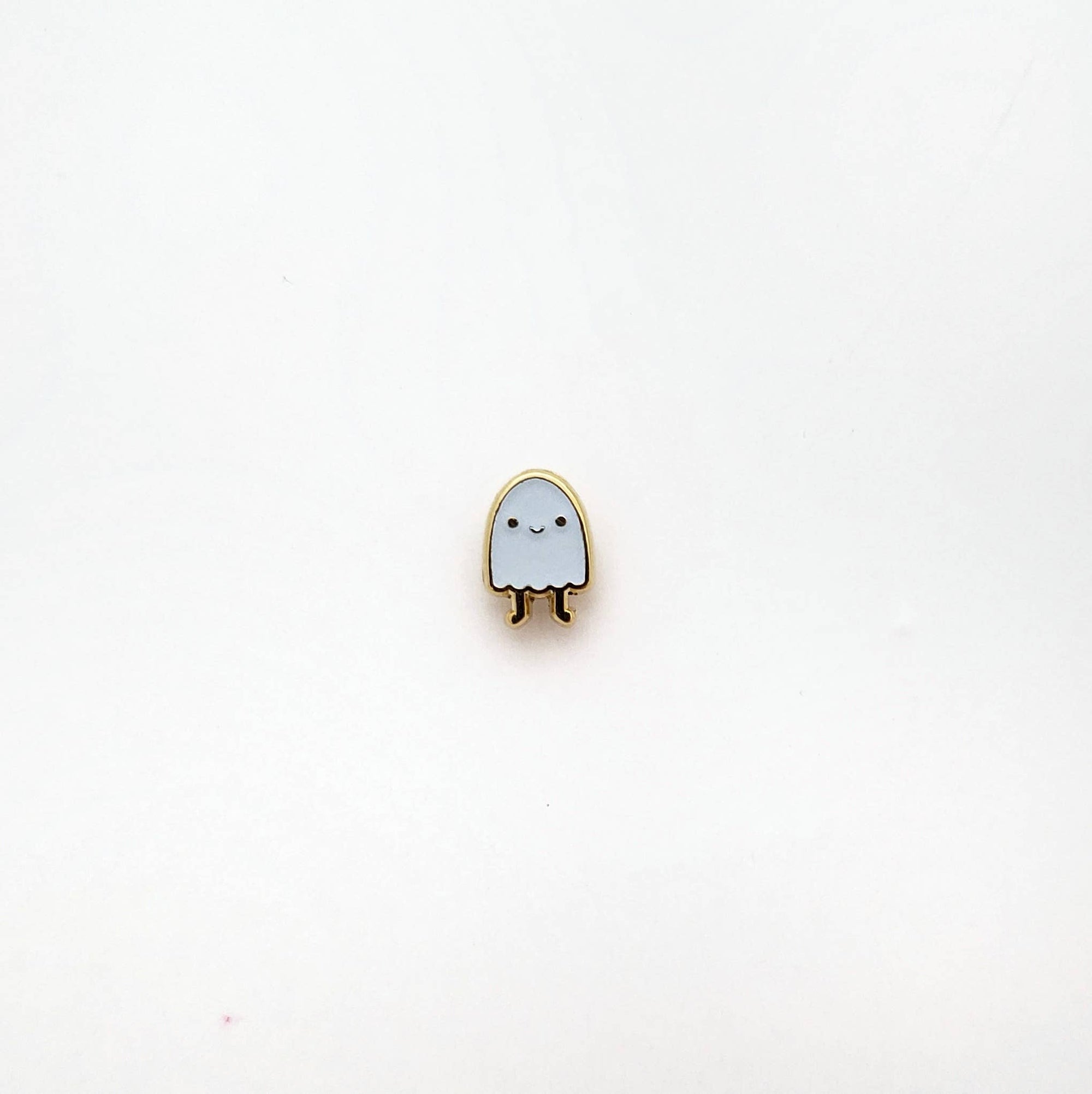 Small ghost-shaped pin on a white background