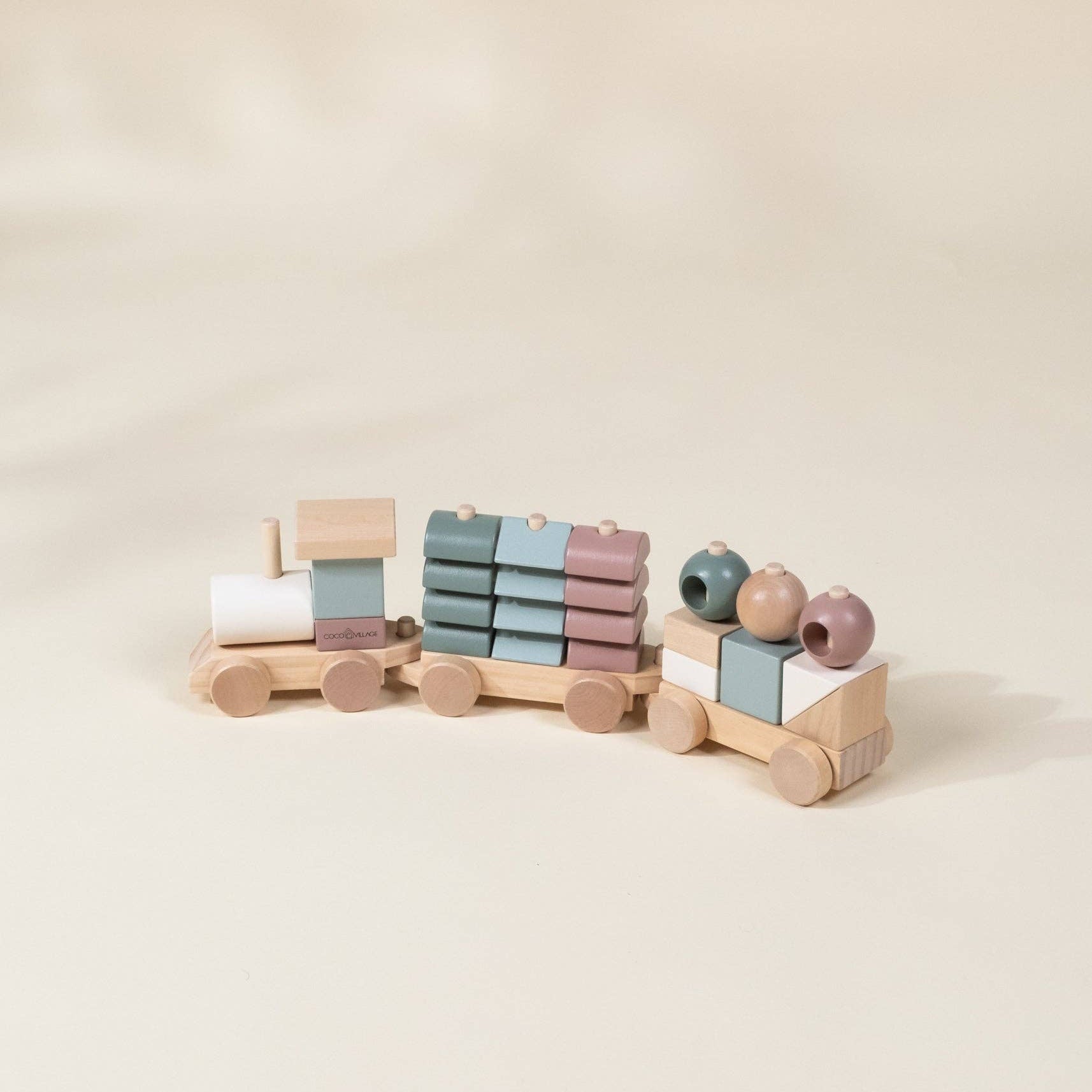 Set of wooden building blocks with pastel colors on a beige background