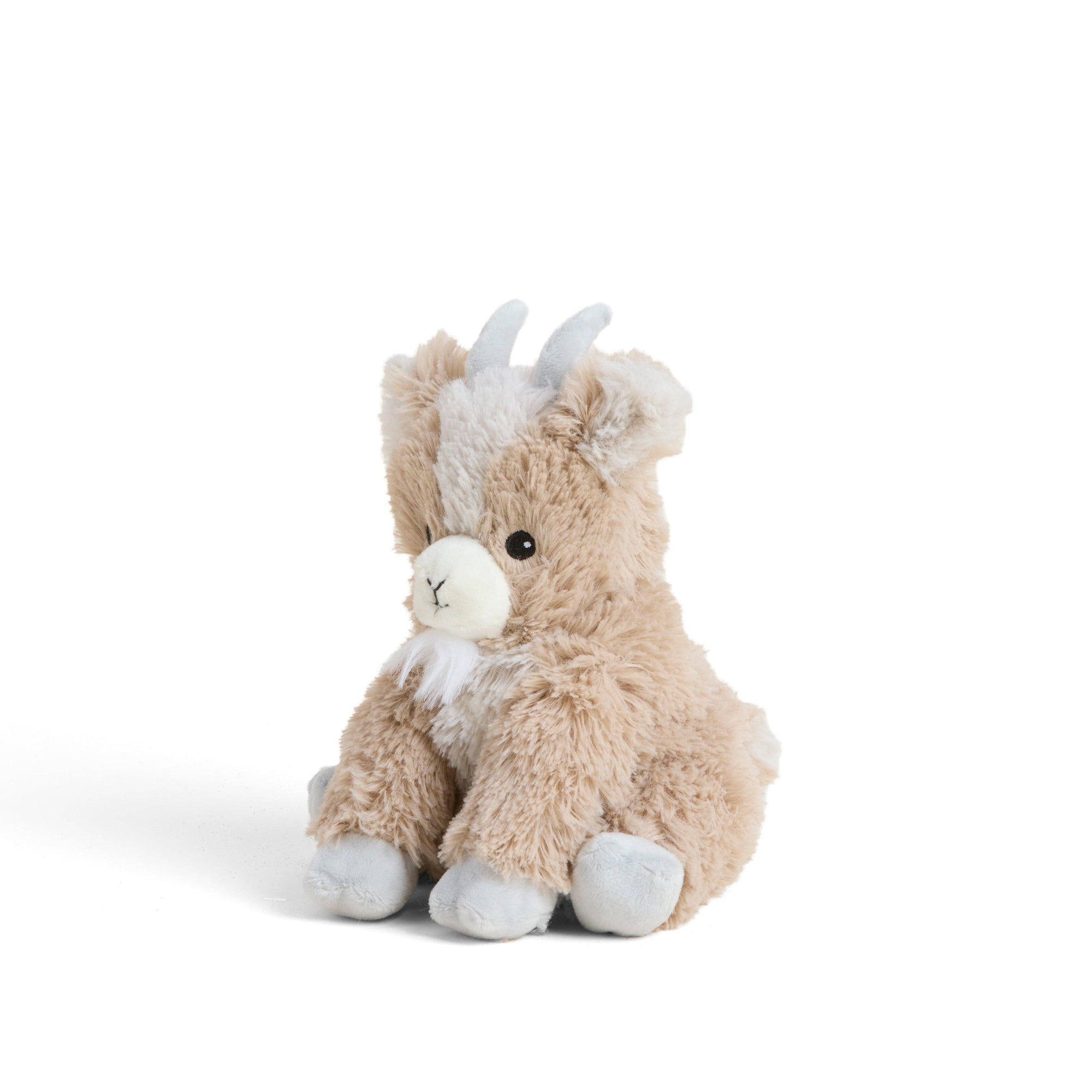 Plush toy goat with white accents on a light beige background