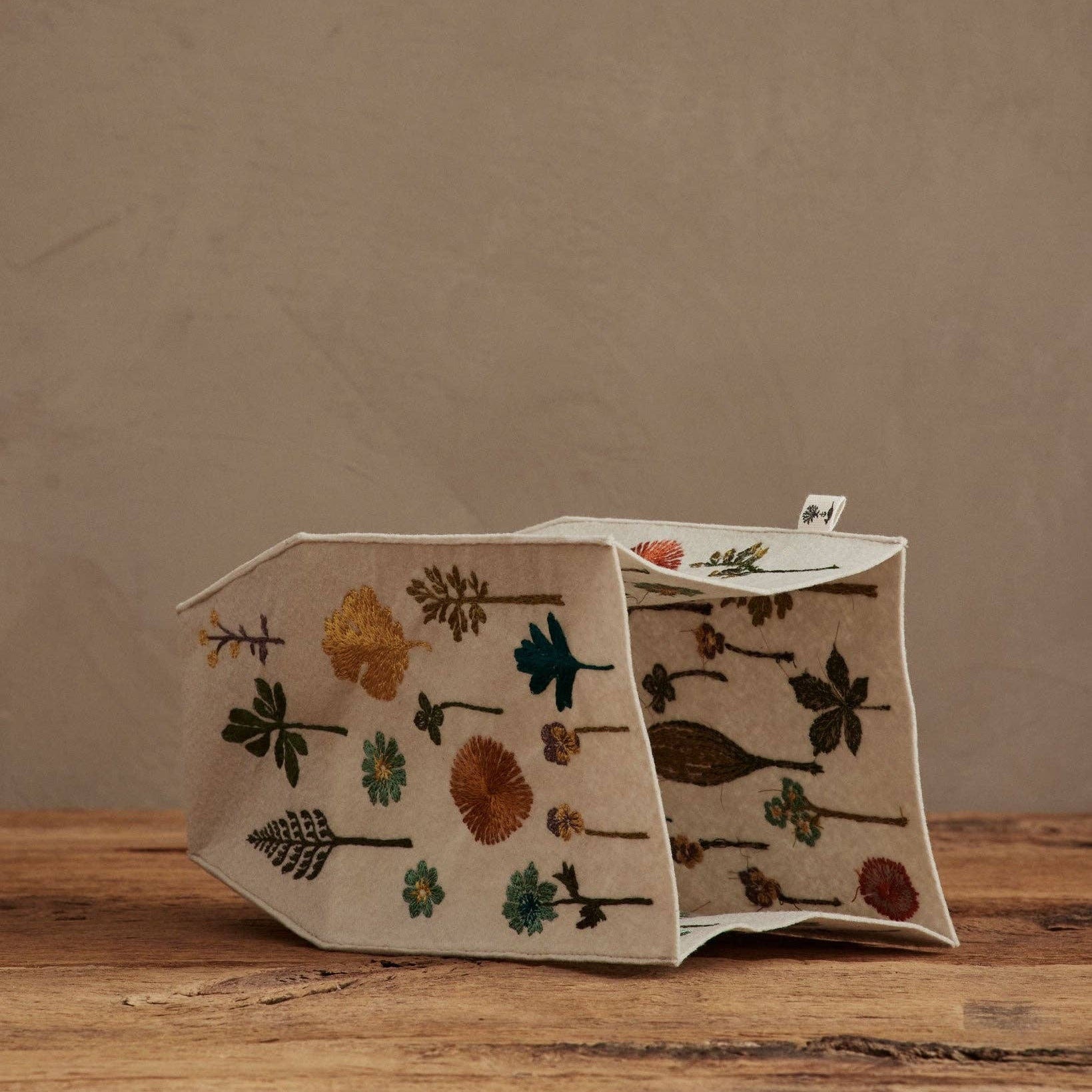 Decorative box with floral patterns on a wooden surface and brown background