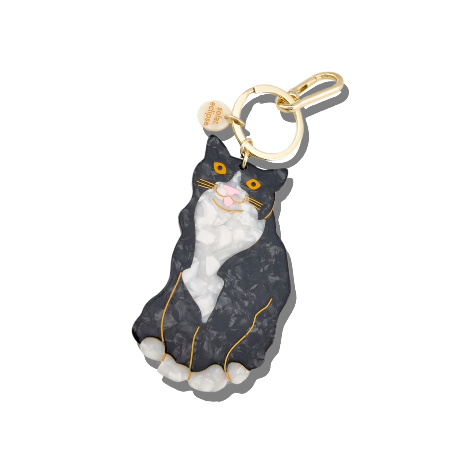 Cat-shaped keychain with gold chain on a white background
