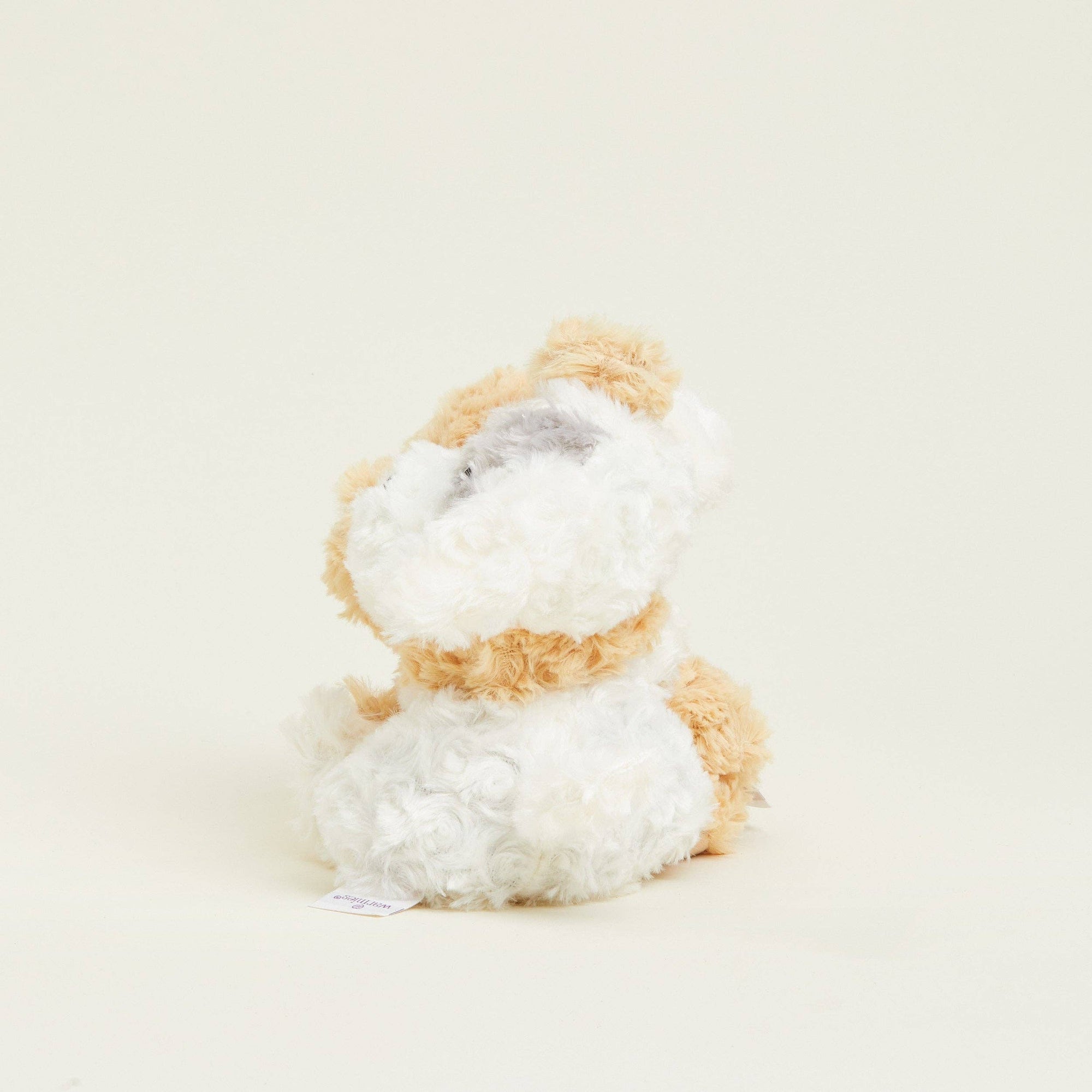Plush toy resembling a lion on a light beige background