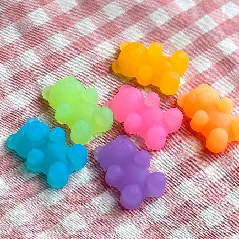 Colorful bear-shaped candies on a checkered fabric background