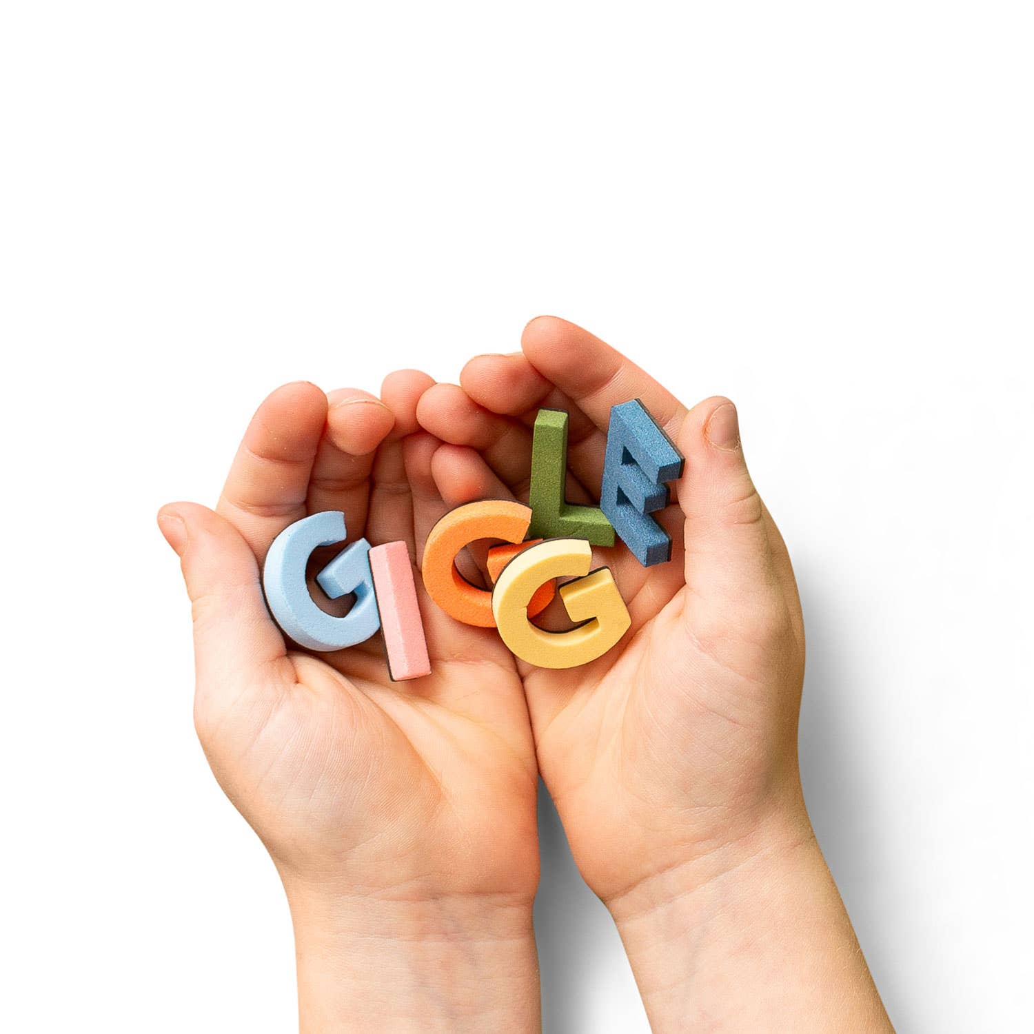 Colorful letter blocks spelling 'GIGGLe' held in hands against a white background