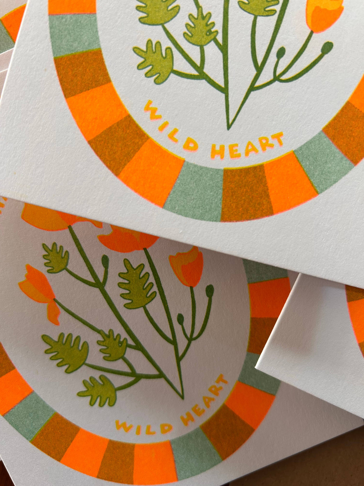 Stickers with floral design and 'Wild Heart' text on a white background