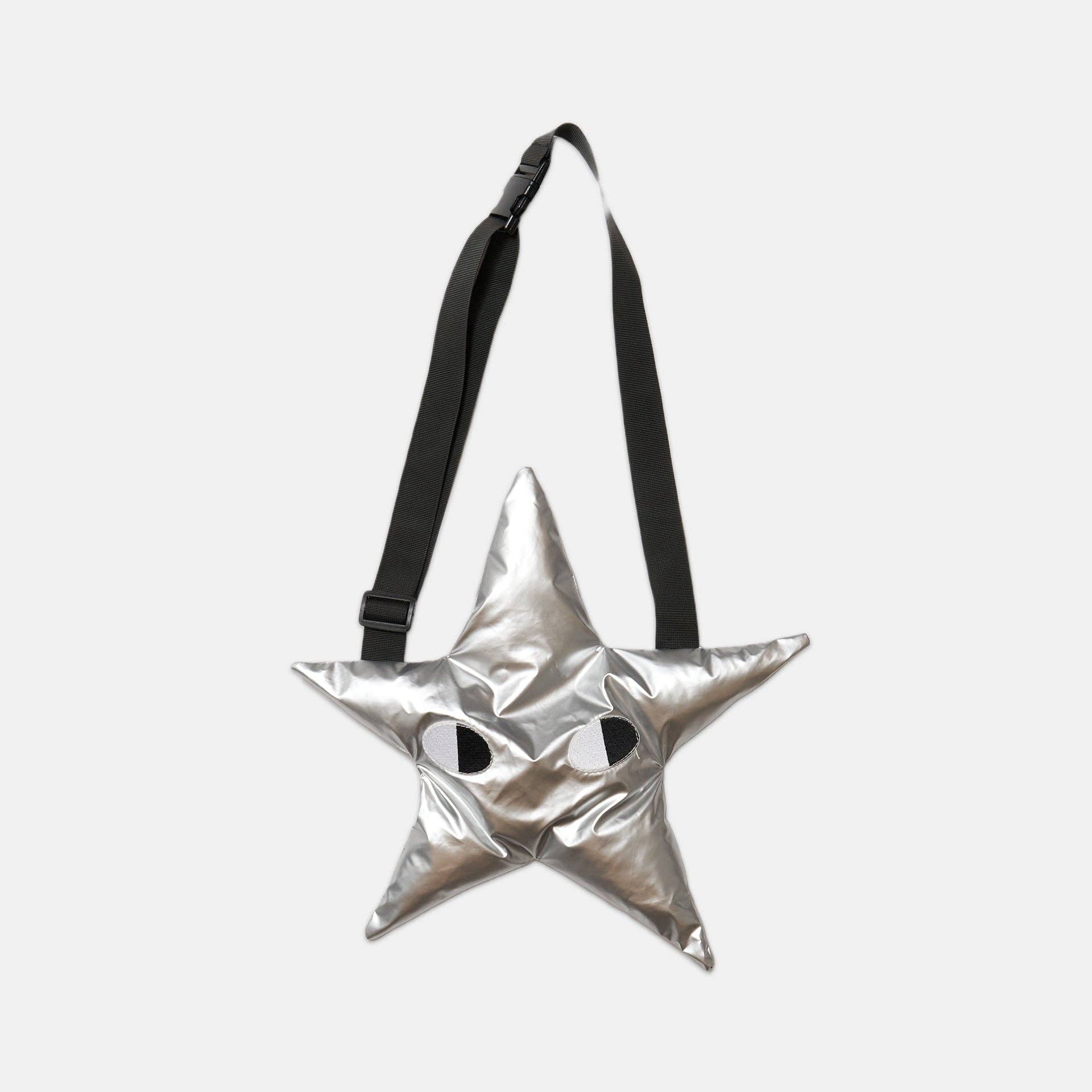 Silver star-shaped bag with a black strap on a light gray background