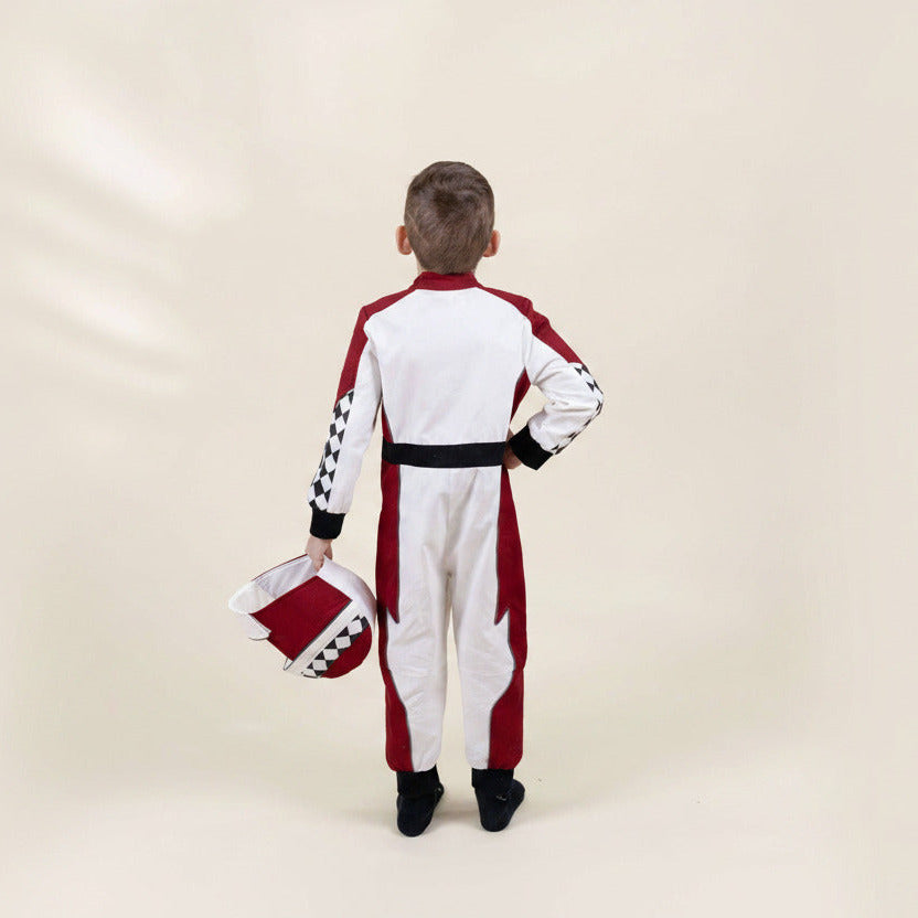 Child wearing a red and white racing suit with a helmet on a beige background