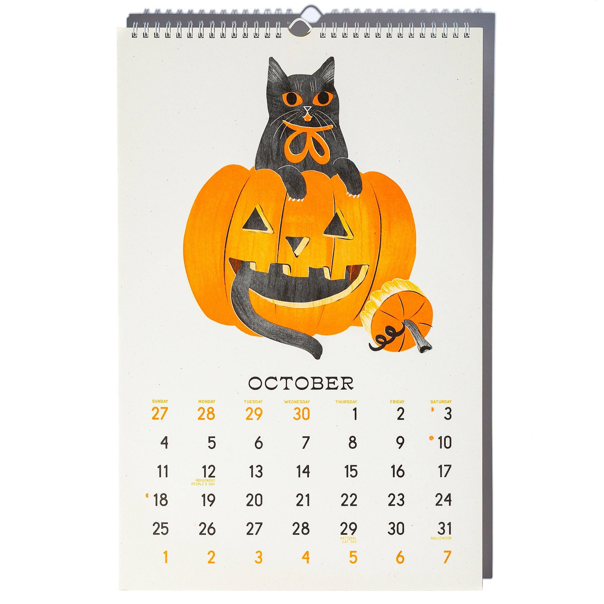 Calendar with a Halloween design featuring a black cat on a pumpkin, on a white background.
