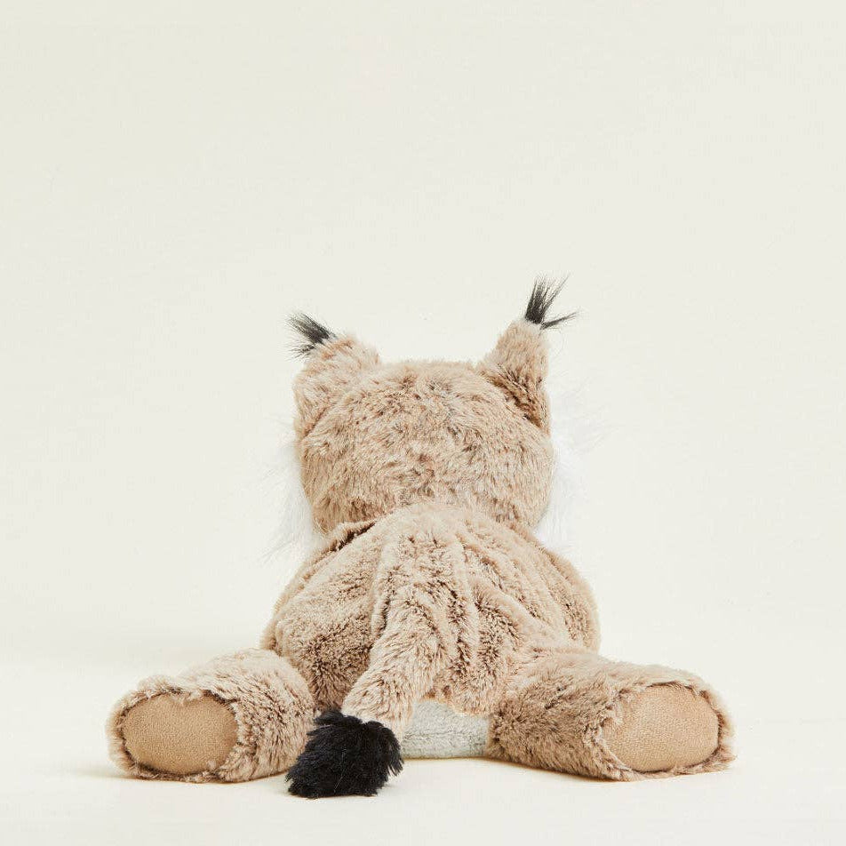 Plush toy resembling a cat with fluffy tail on a white background