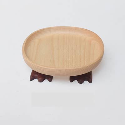 Wooden stand with a round wooden plate on a white background