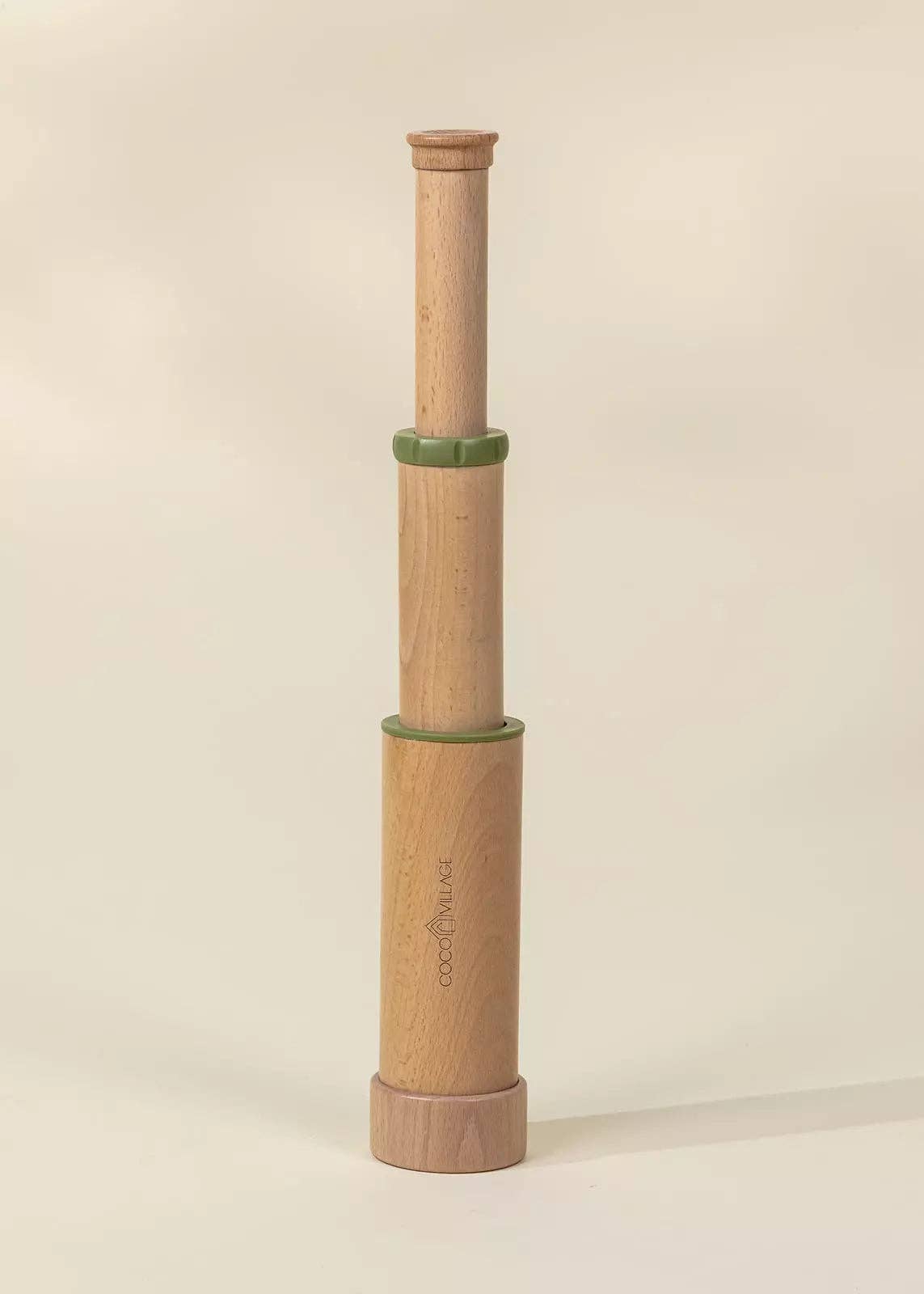 Wooden pepper grinder with a beige background