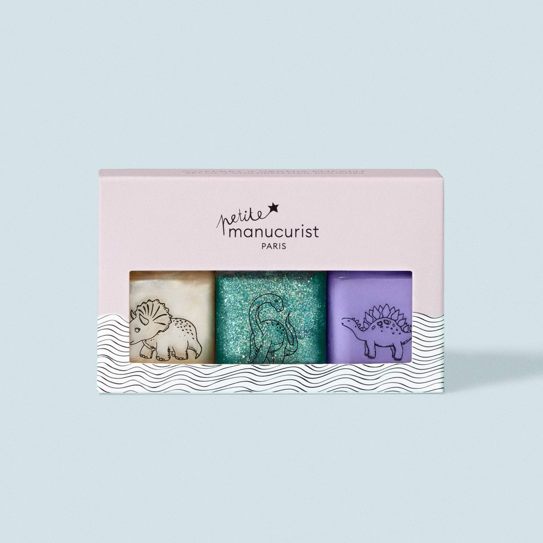 Set of three nail art polishes in a 'petite manucurist' box on a light blue background