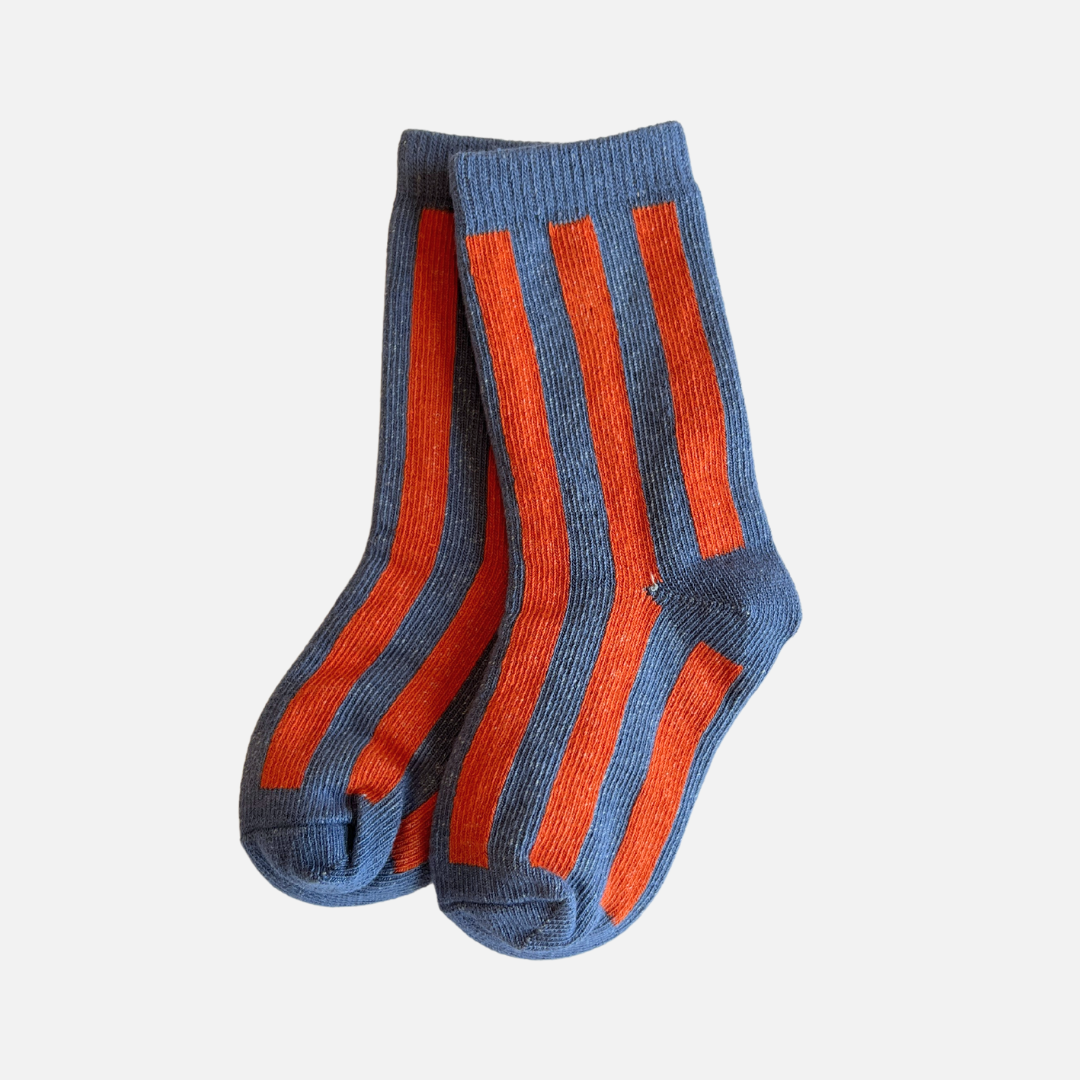 Pair of blue and orange striped socks on a white background