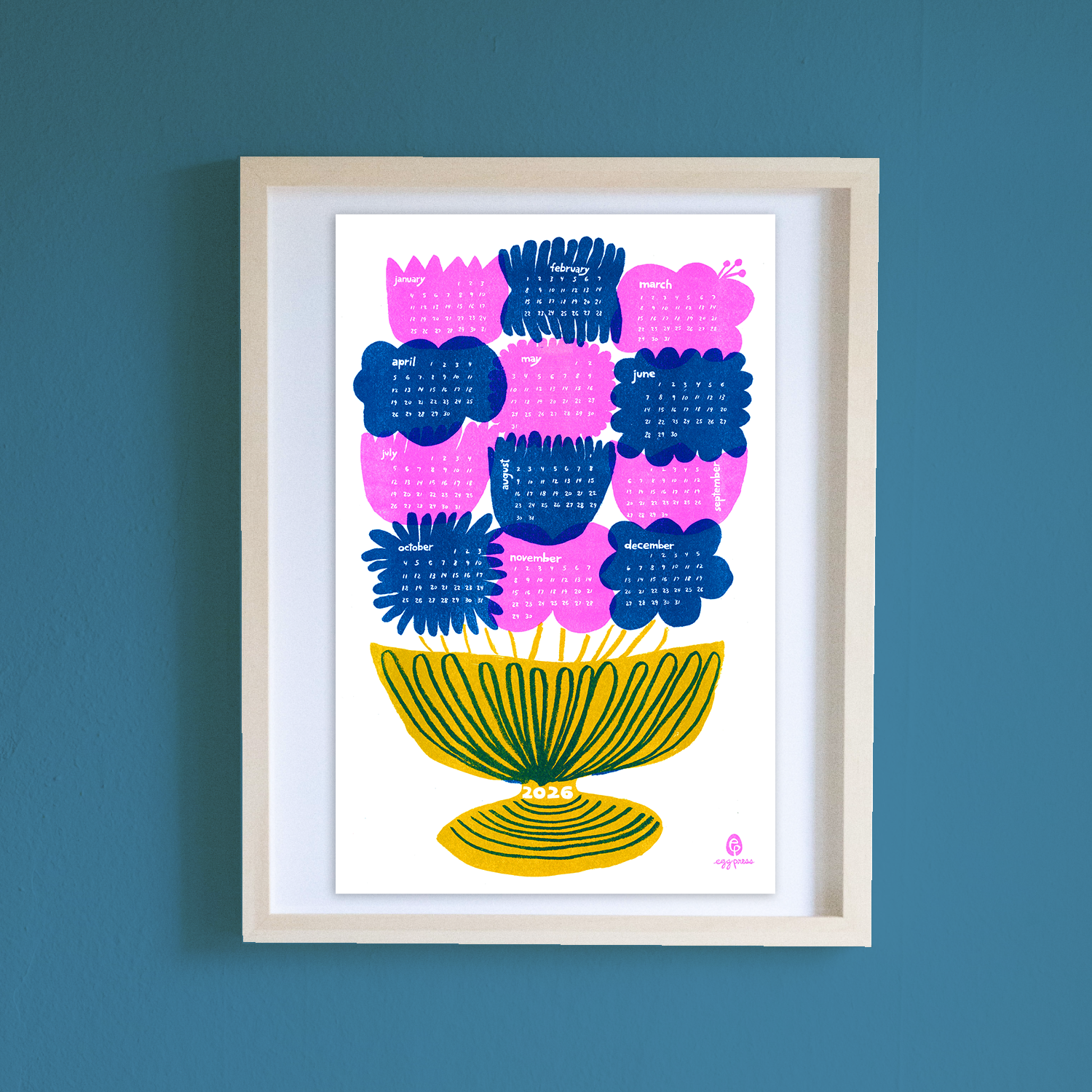 Framed artwork with colorful floral design on a blue wall