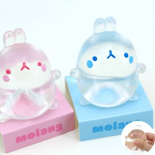 Two cute figurines, one pink and one blue, on their respective boxes with 'molang' branding.