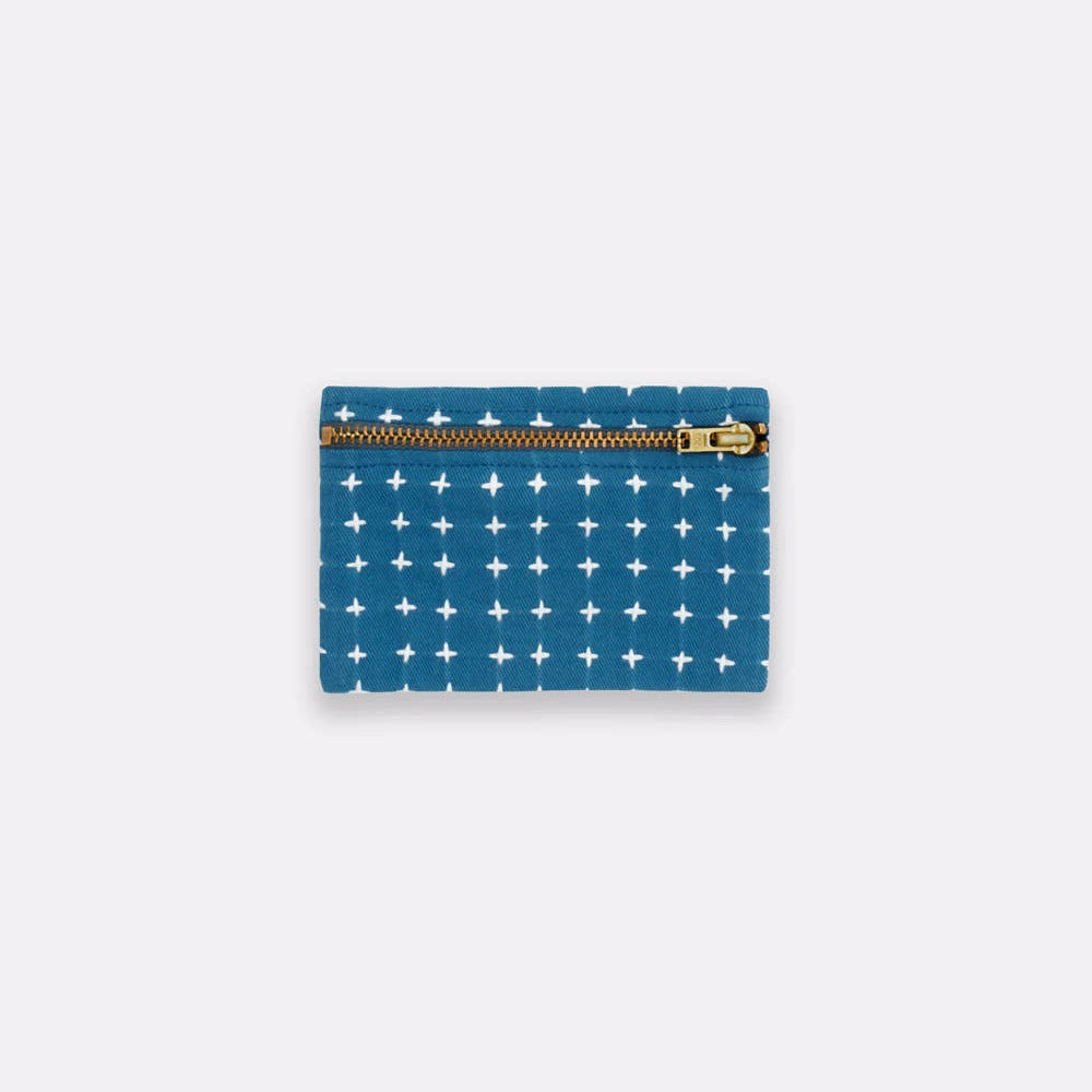 Blue pouch with white star pattern and gold zipper on a light gray background