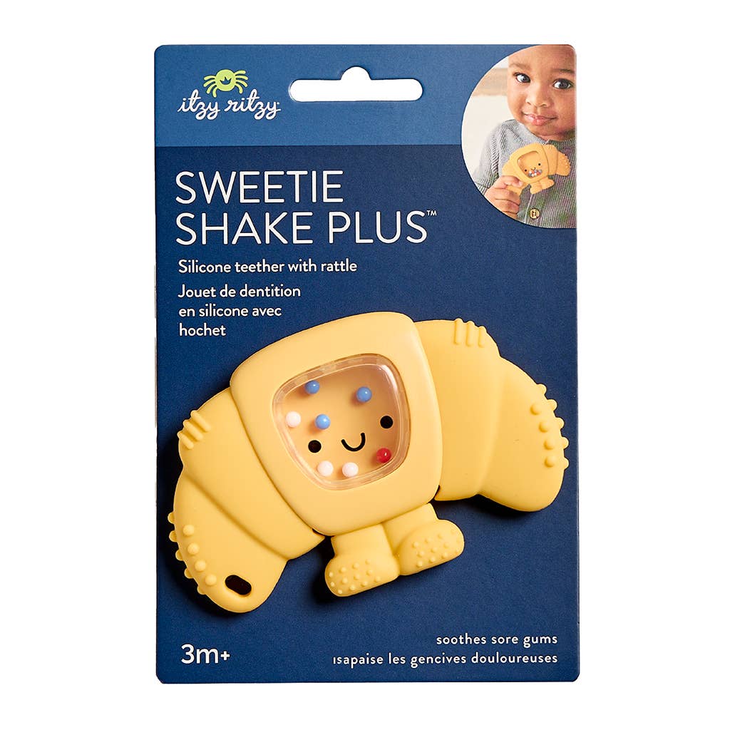 Yellow pastert-shaped silicone teether with rattle on its packaging, featuring the brand 'itzy ritzy'.