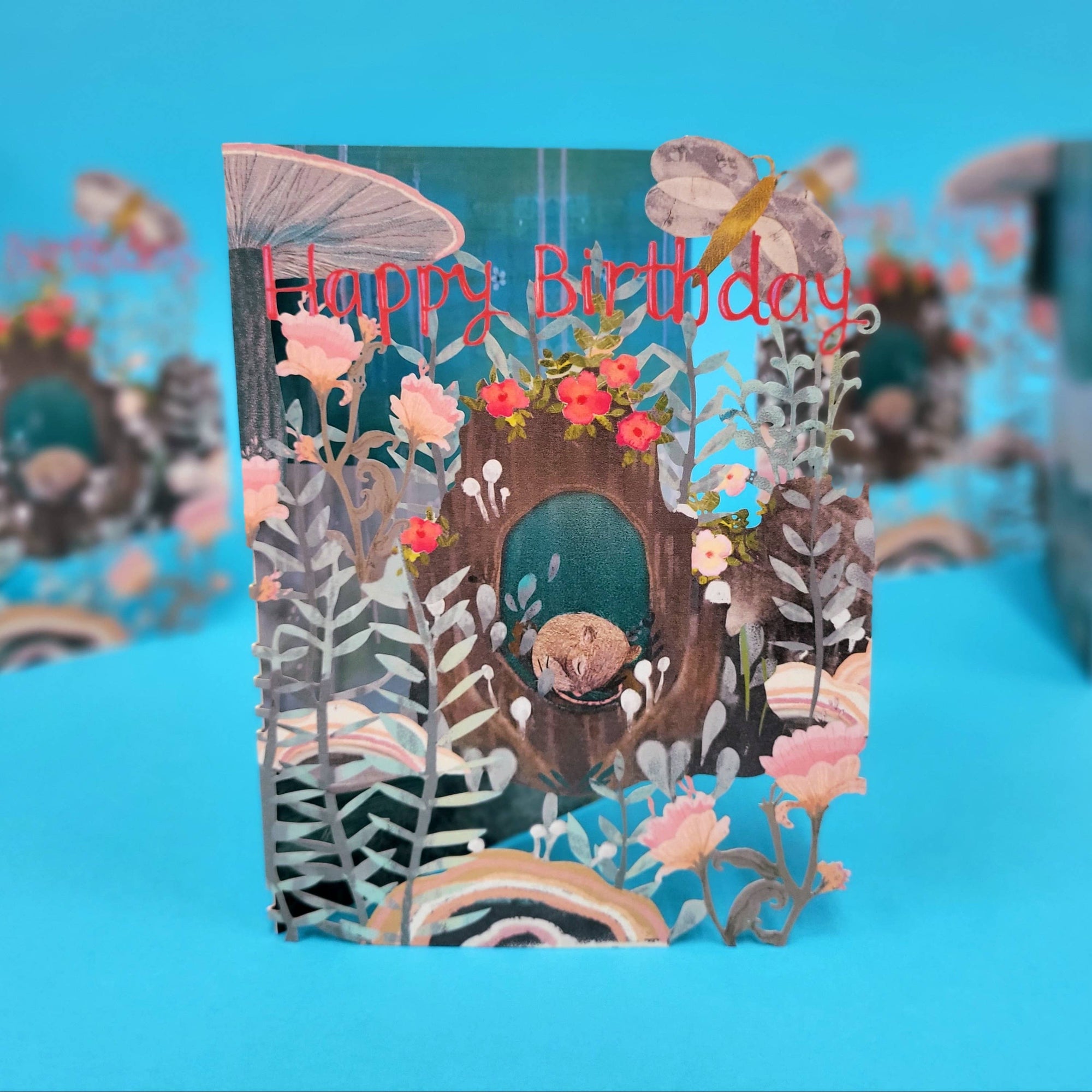 Birthday card with floral design and 'Happy Birthday' text on a blue background