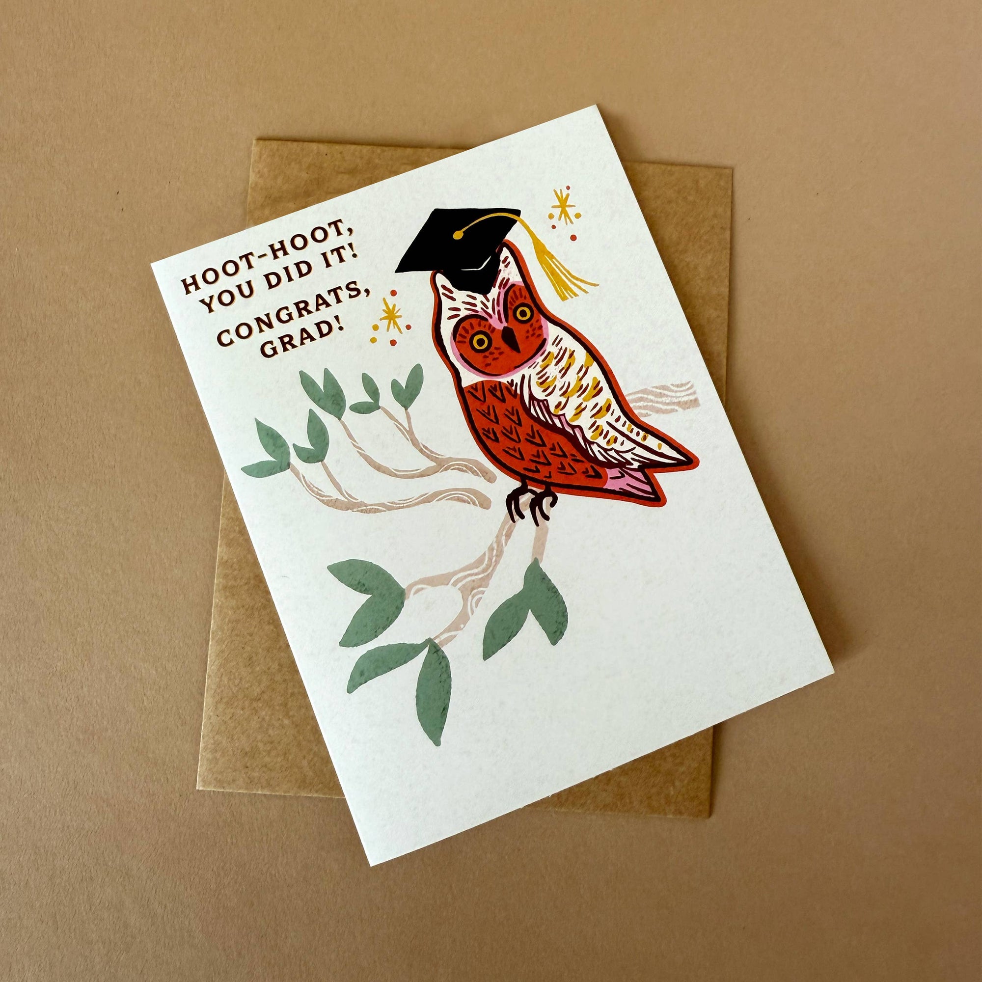 Graduation card with an owl wearing a cap and tassel on a brown background