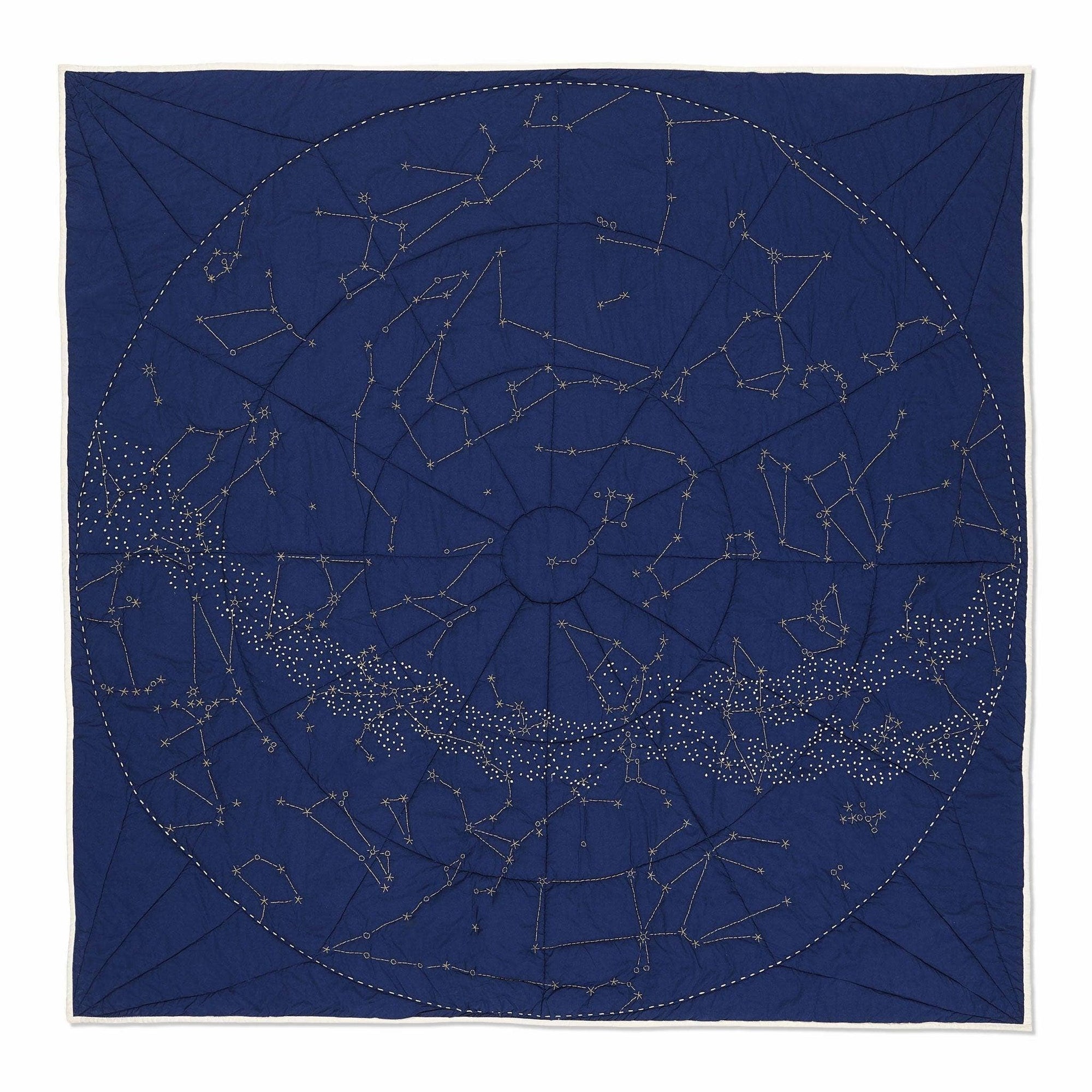 Navy blue quilt with star constellations pattern on a white background