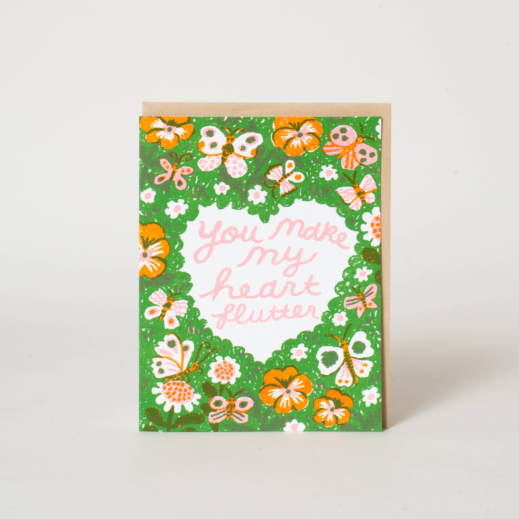 Greeting card with floral design and text 'You make my heart flutter' on a white background