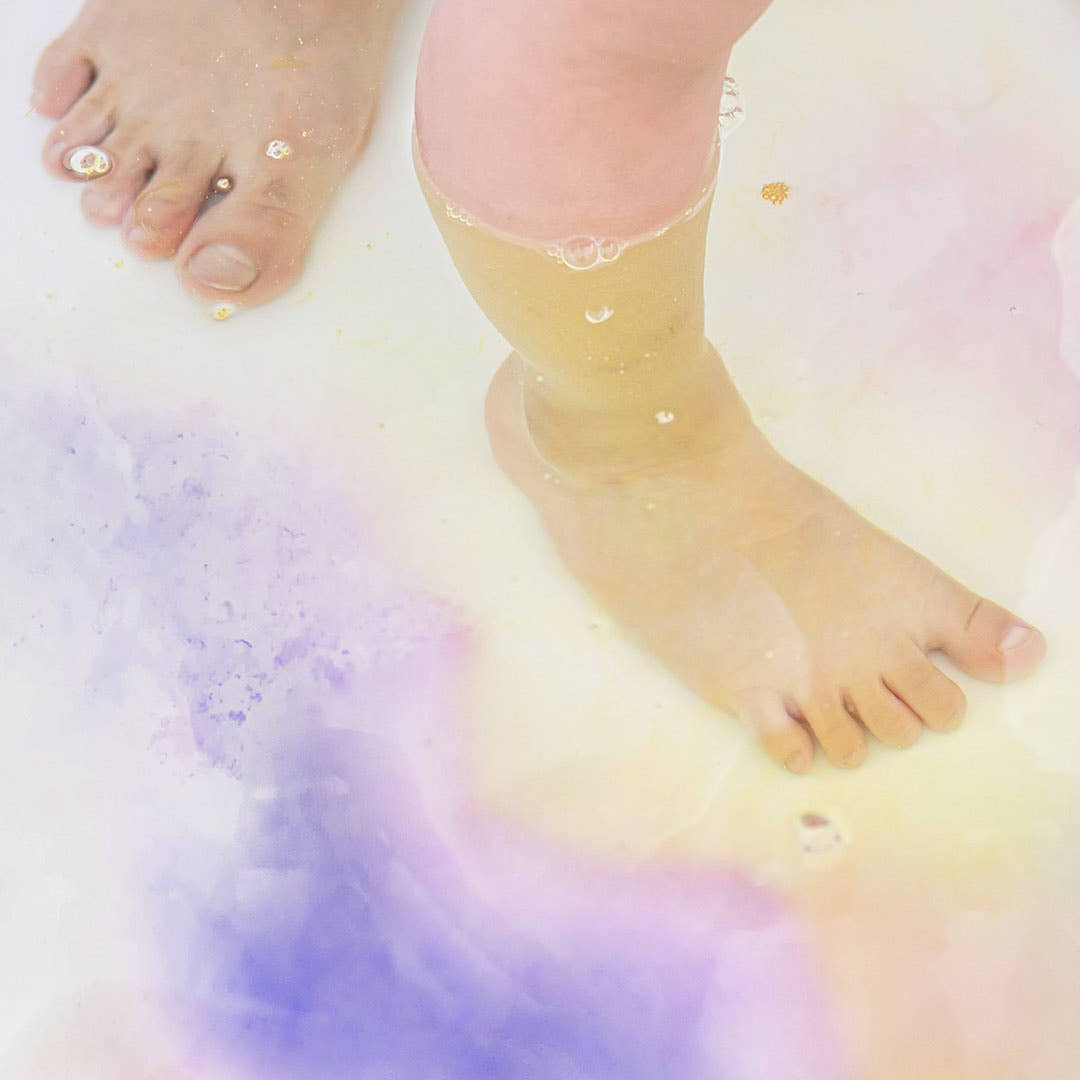 Close-up of bare feet on a colorful, gradient background