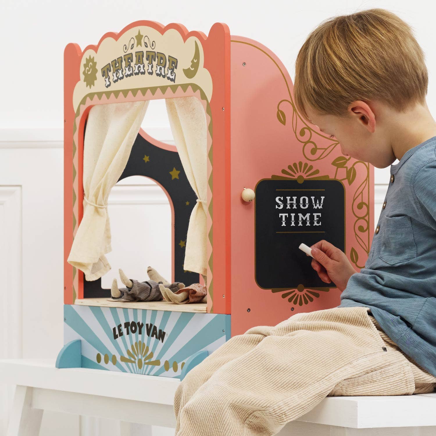 Child playing with a Le Toy Van puppet theatre