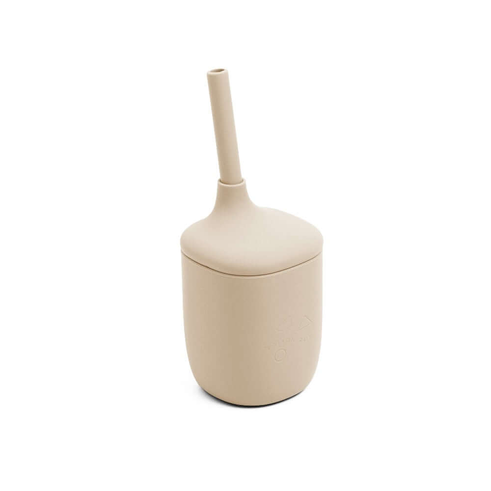 Beige sippie cup with a long straw on a white background
