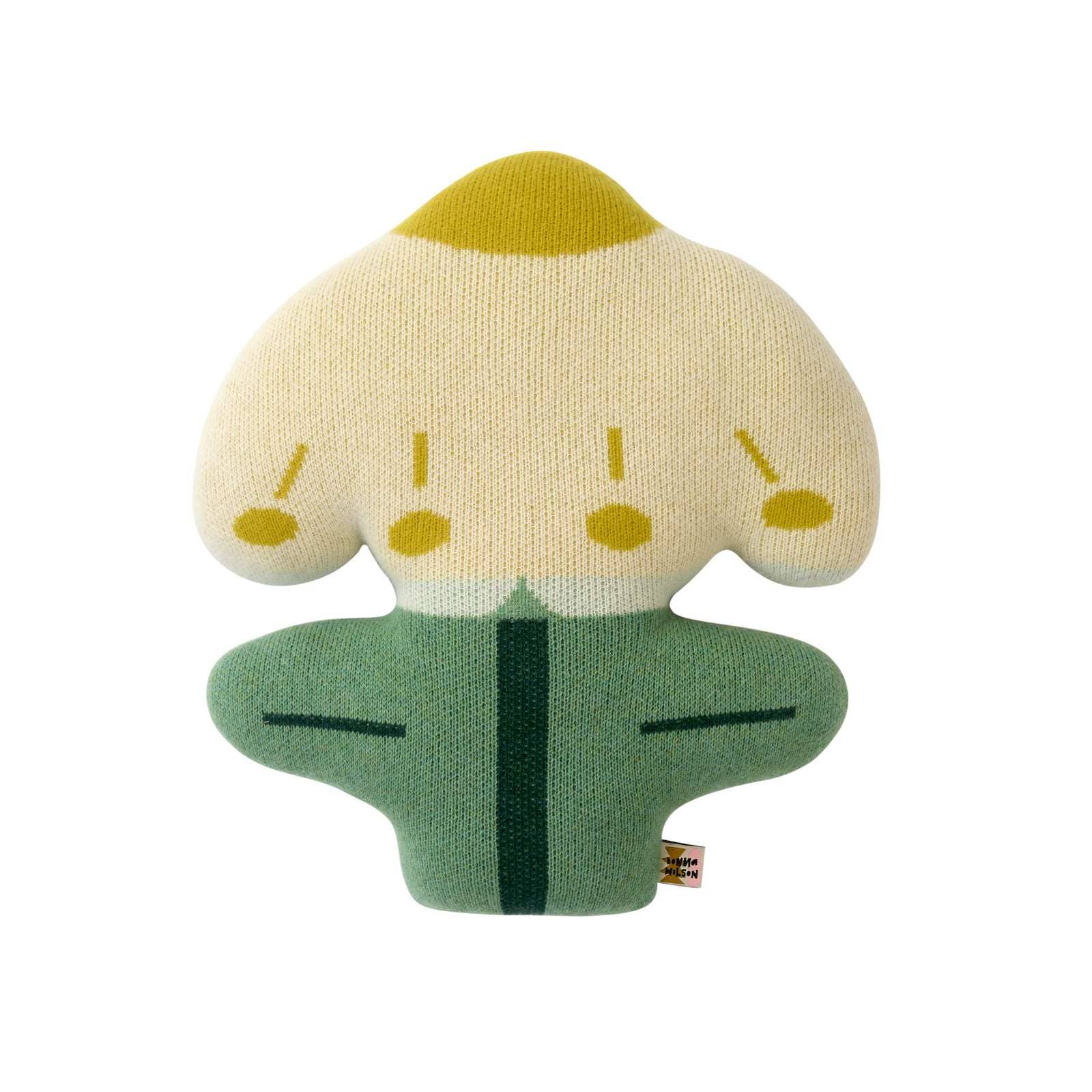 A plush flower-shaped baby teether or toy with a cream-colored top, yellow accents, and a green bottom, photographed on a solid white background.